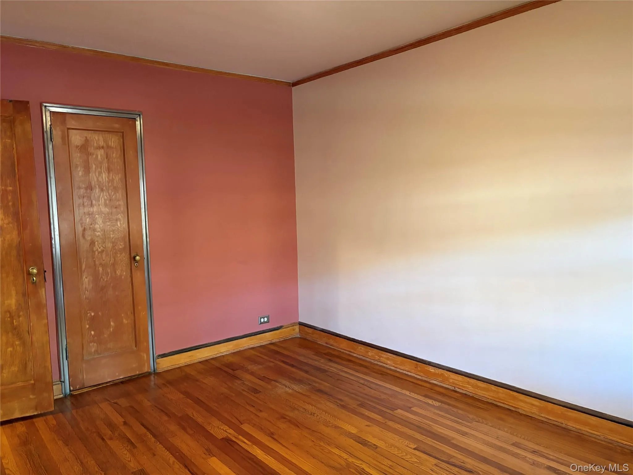 Empty room with wood finished floors and ornamental molding Empty room with wood finished floors and ornamental molding