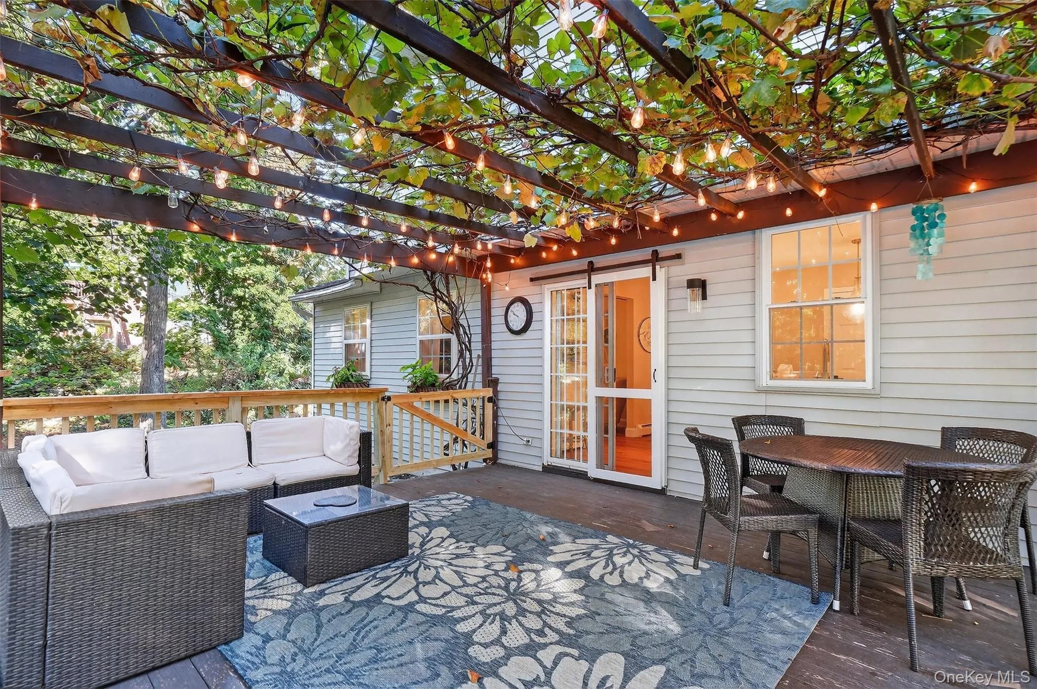 Wooden terrace featuring outdoor dining area and an outdoor living space Wooden terrace featuring outdoor dining area and an outdoor living space