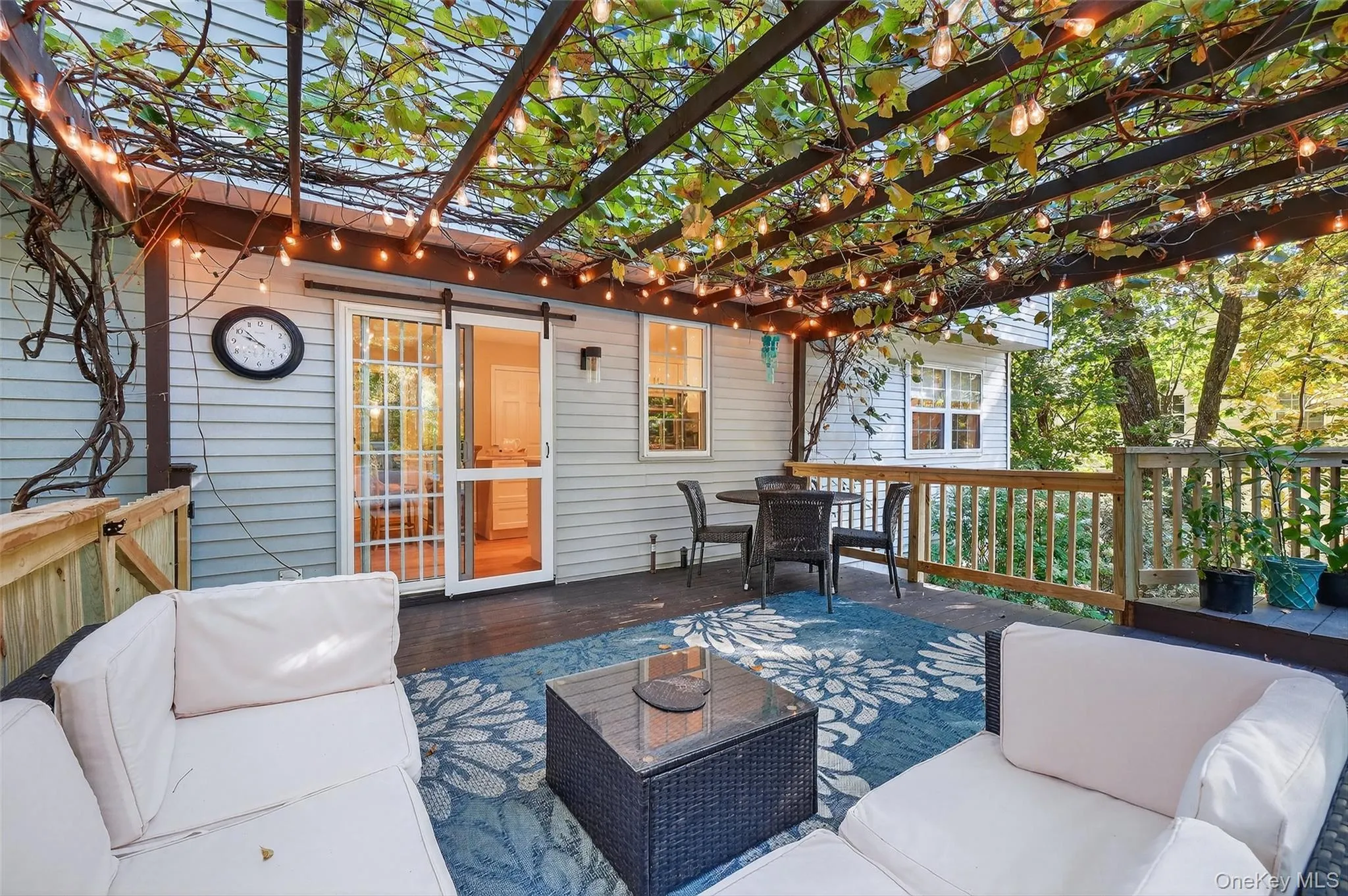 Wooden deck with an outdoor living space and outdoor dining area Wooden deck with an outdoor living space and outdoor dining area