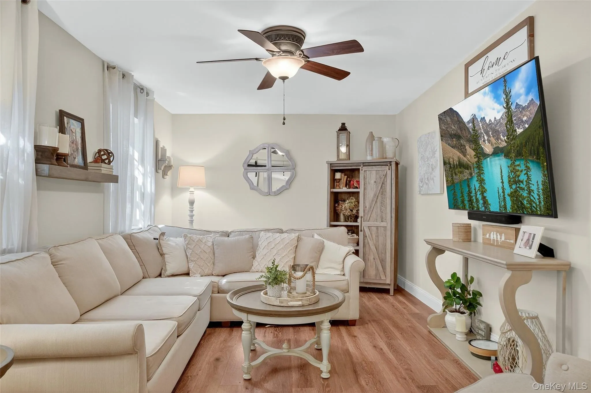 Living room featuring wood finished floors and ceiling fan Living room featuring wood finished floors and ceiling fan