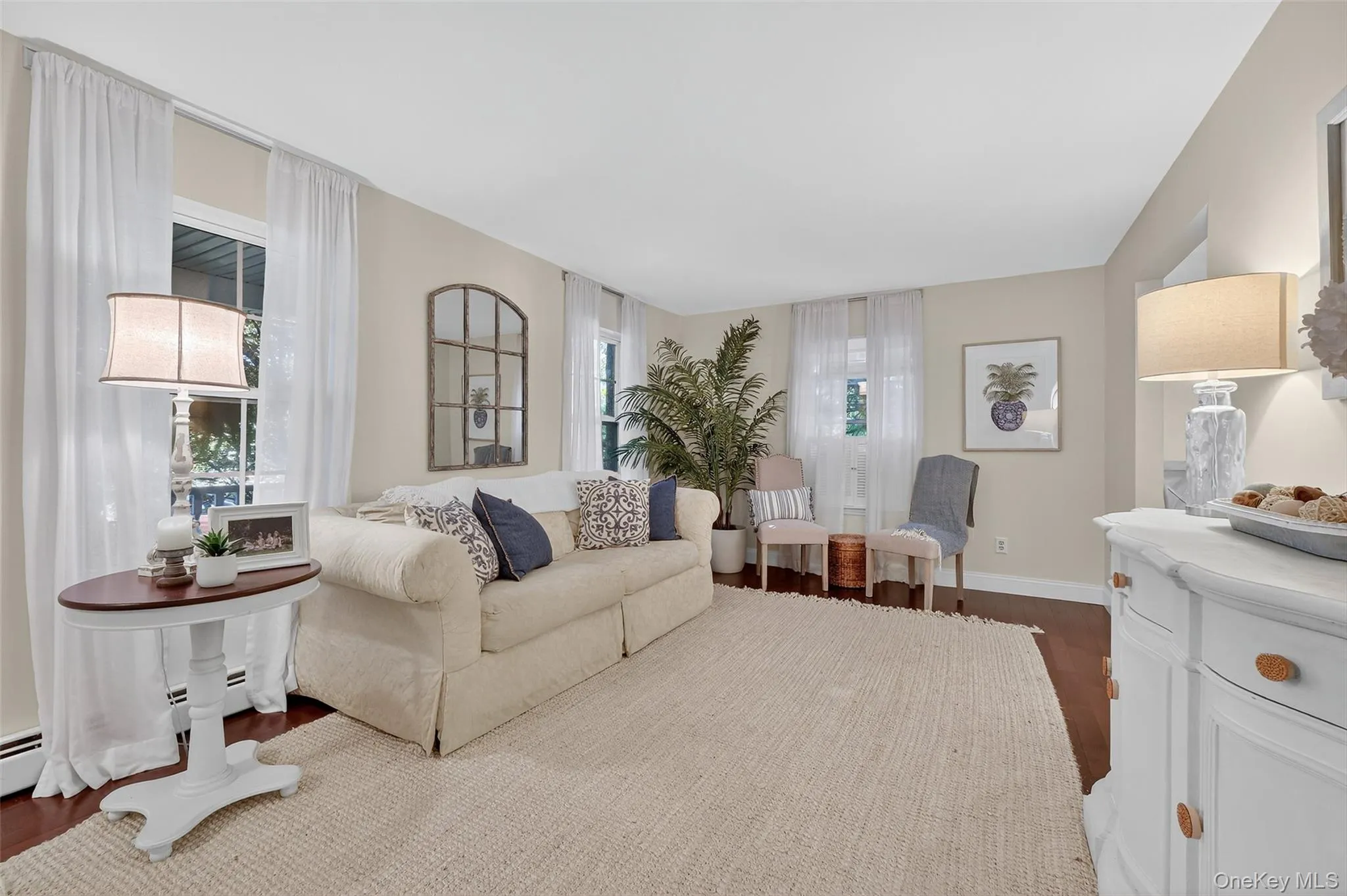 Living area with dark wood-style flooring and baseboards Living area with dark wood-style flooring and baseboards