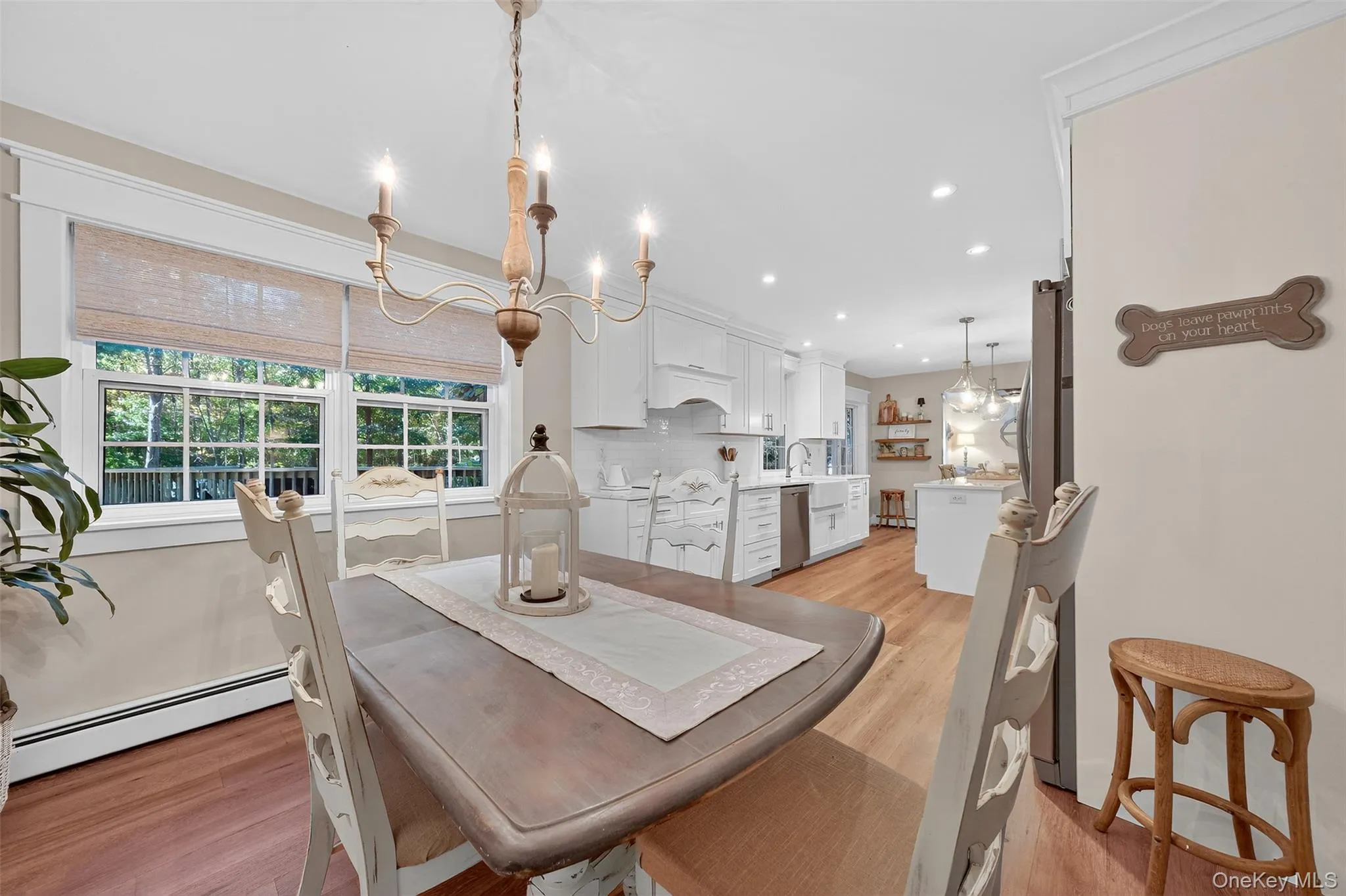 Dining space with a chandelier, baseboard heating, light wood finished floors, and recessed lighting Dining space with a chandelier, baseboard heating, light wood finished floors, and recessed lighting