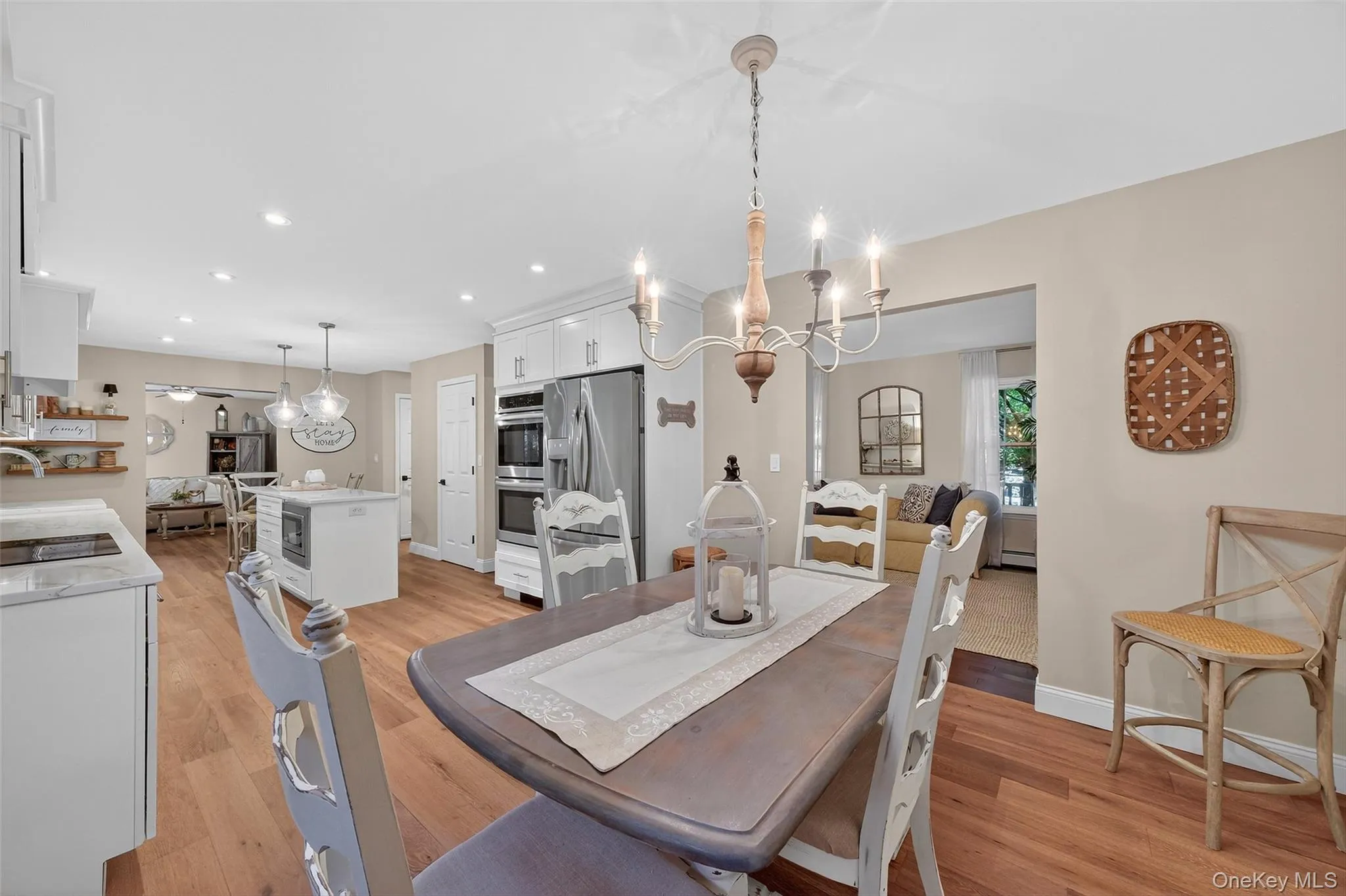 Dining space featuring light wood finished floors, recessed lighting, and a chandelier Dining space featuring light wood finished floors, recessed lighting, and a chandelier