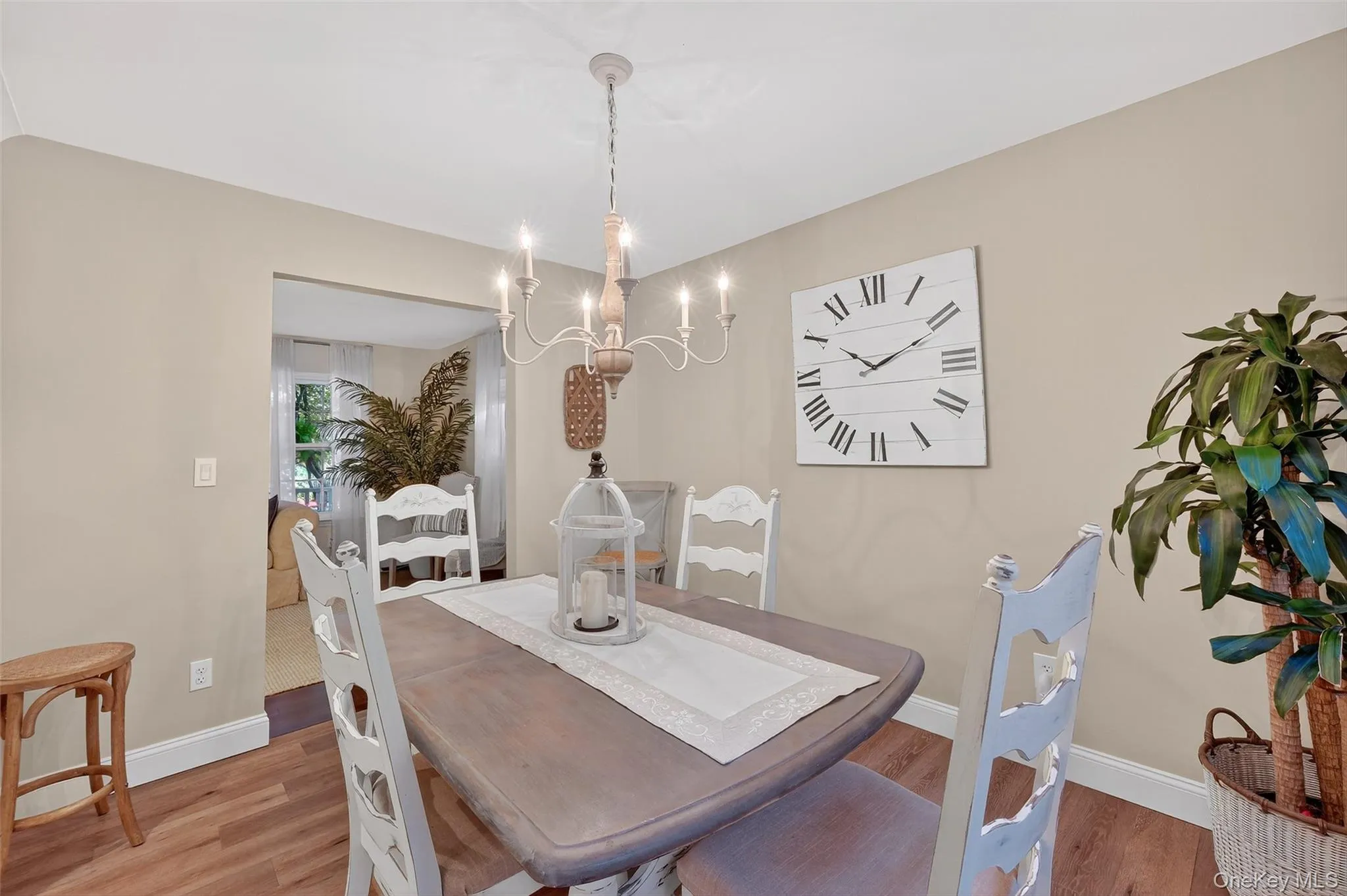 Dining area featuring wood finished floors and a chandelier Dining area featuring wood finished floors and a chandelier