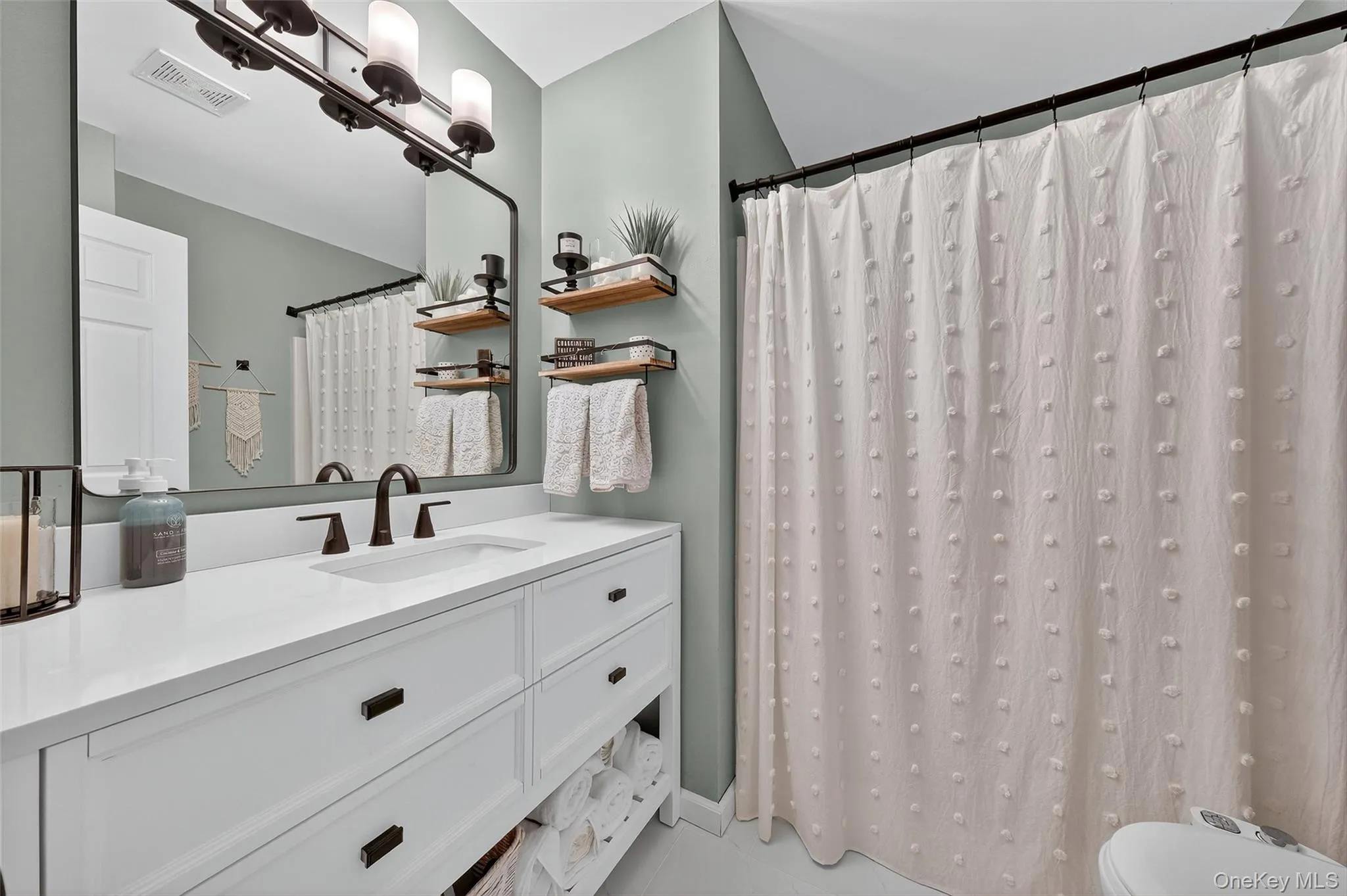Full bathroom with vanity and a shower with shower curtain Full bathroom with vanity and a shower with shower curtain