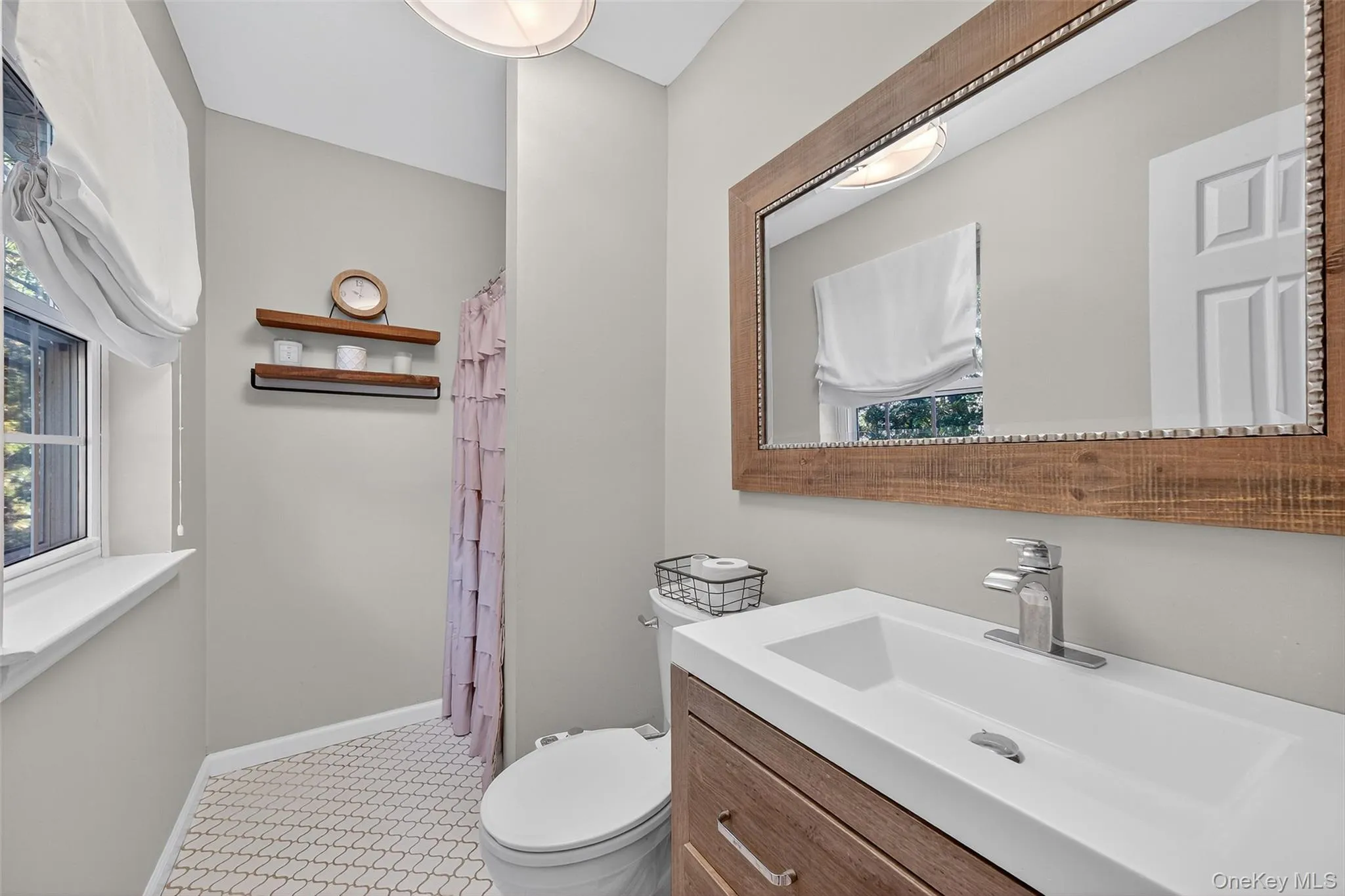 Full bathroom with vanity, a shower with curtain, and light tile patterned floors Full bathroom with vanity, a shower with curtain, and light tile patterned floors