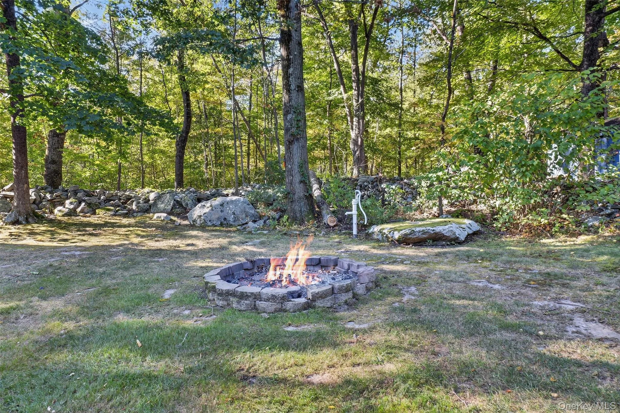 View of yard featuring a fire pit View of yard featuring a fire pit