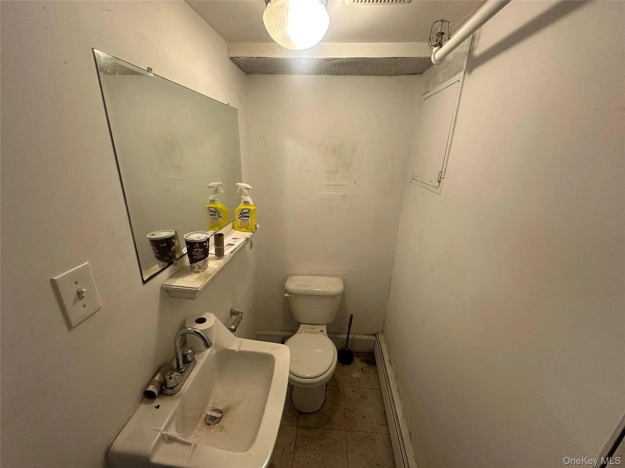 Bathroom with a baseboard heating unit and light tile patterned flooring Bathroom with a baseboard heating unit and light tile patterned flooring