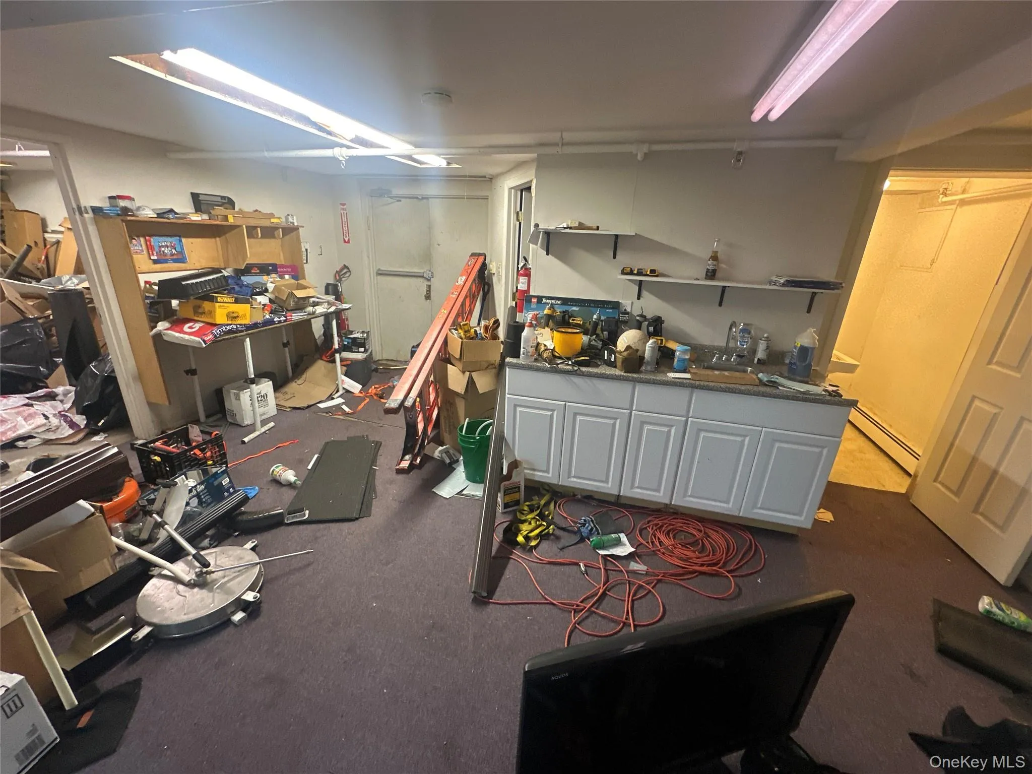 Basement featuring a baseboard radiator and a workshop area Basement featuring a baseboard radiator and a workshop area