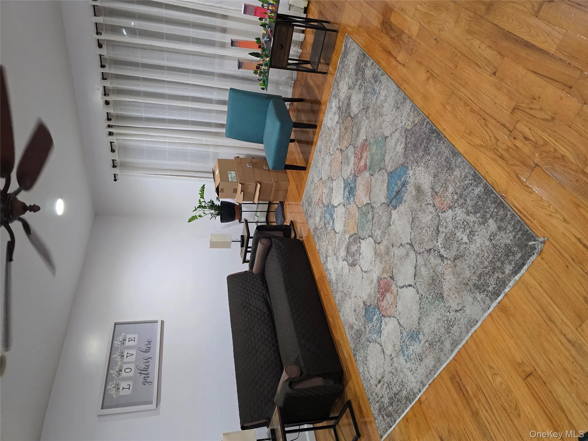 Living area with wood finished floors, a ceiling fan, and recessed lighting Living area with wood finished floors, a ceiling fan, and recessed lighting