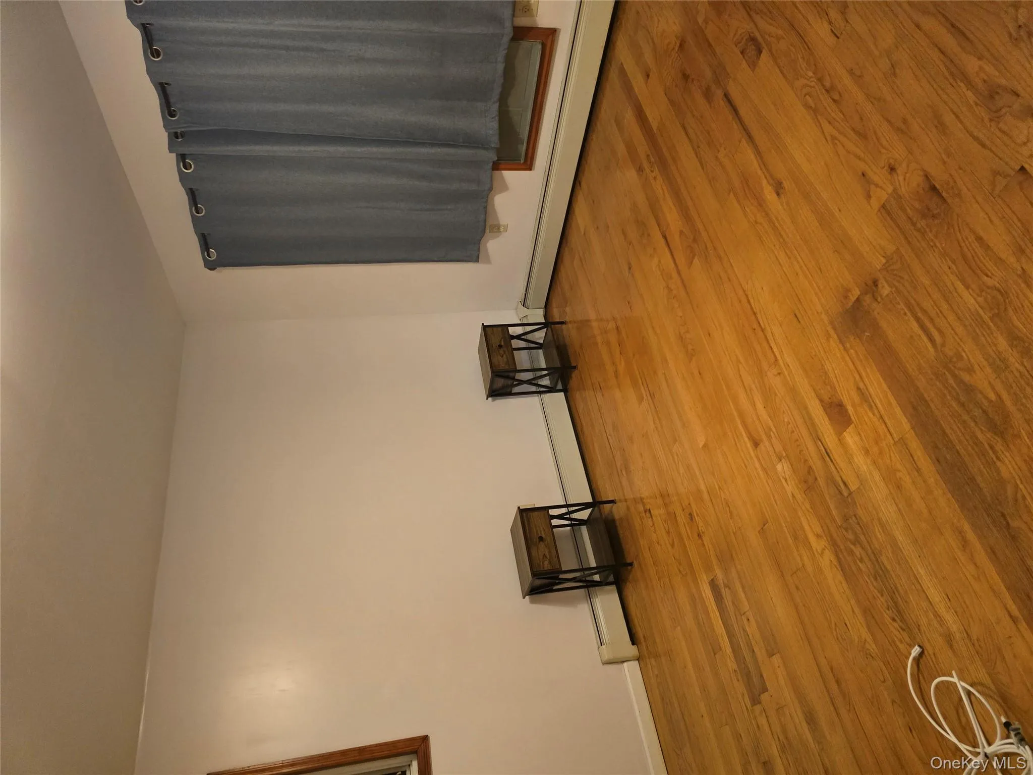 Unfurnished room featuring light wood-style floors and a baseboard heating unit Unfurnished room featuring light wood-style floors and a baseboard heating unit