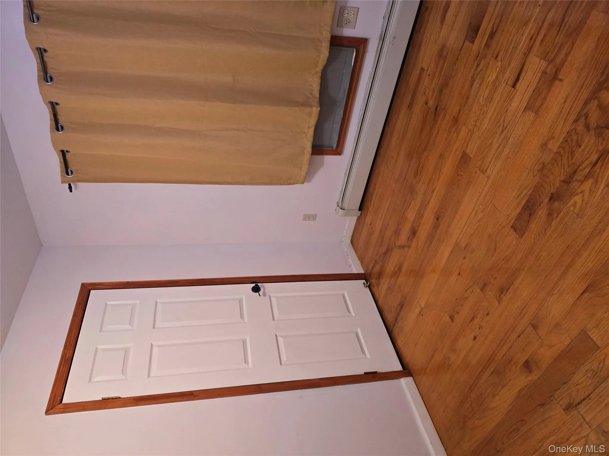 Spare room with a baseboard heating unit and wood finished floors Spare room with a baseboard heating unit and wood finished floors