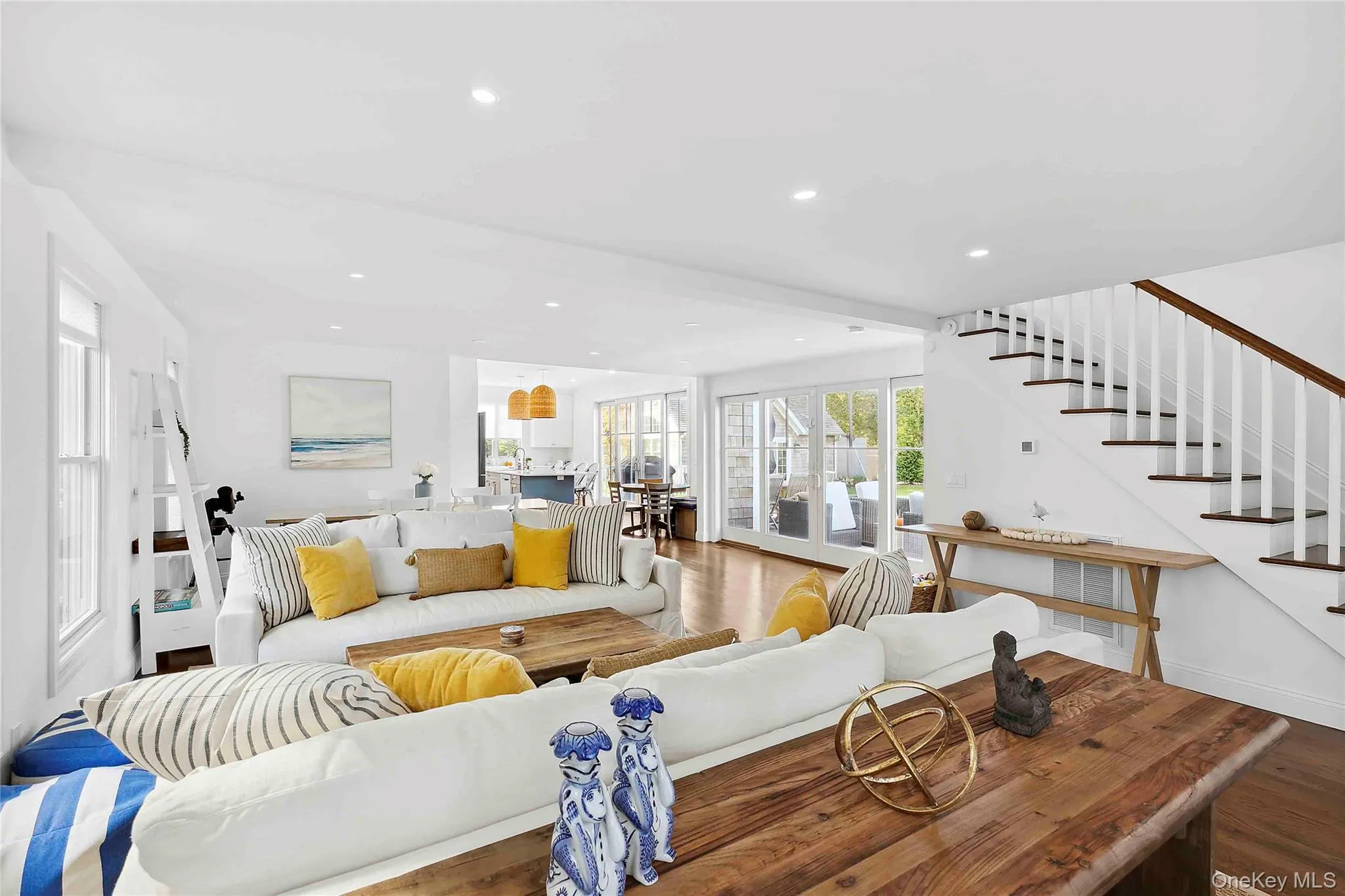 Living room featuring wood finished floors, recessed lighting, and stairway Living room featuring wood finished floors, recessed lighting, and stairway