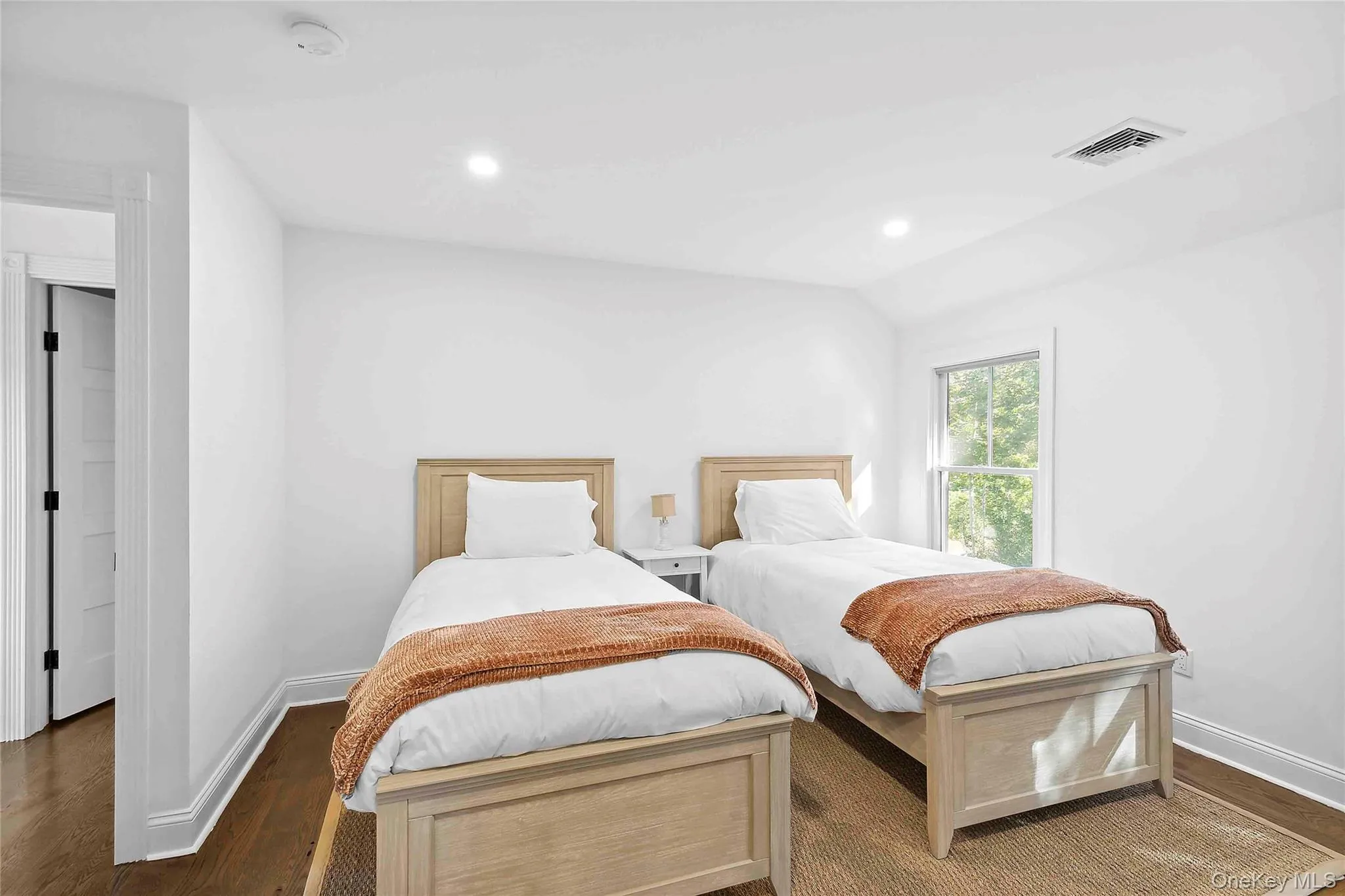 Bedroom featuring dark wood finished floors, recessed lighting, and vaulted ceiling Bedroom featuring dark wood finished floors, recessed lighting, and vaulted ceiling