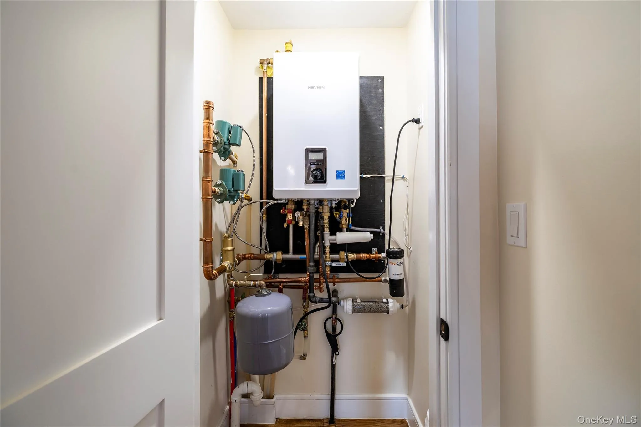 Utility room with tankless water heater Utility room with tankless water heater