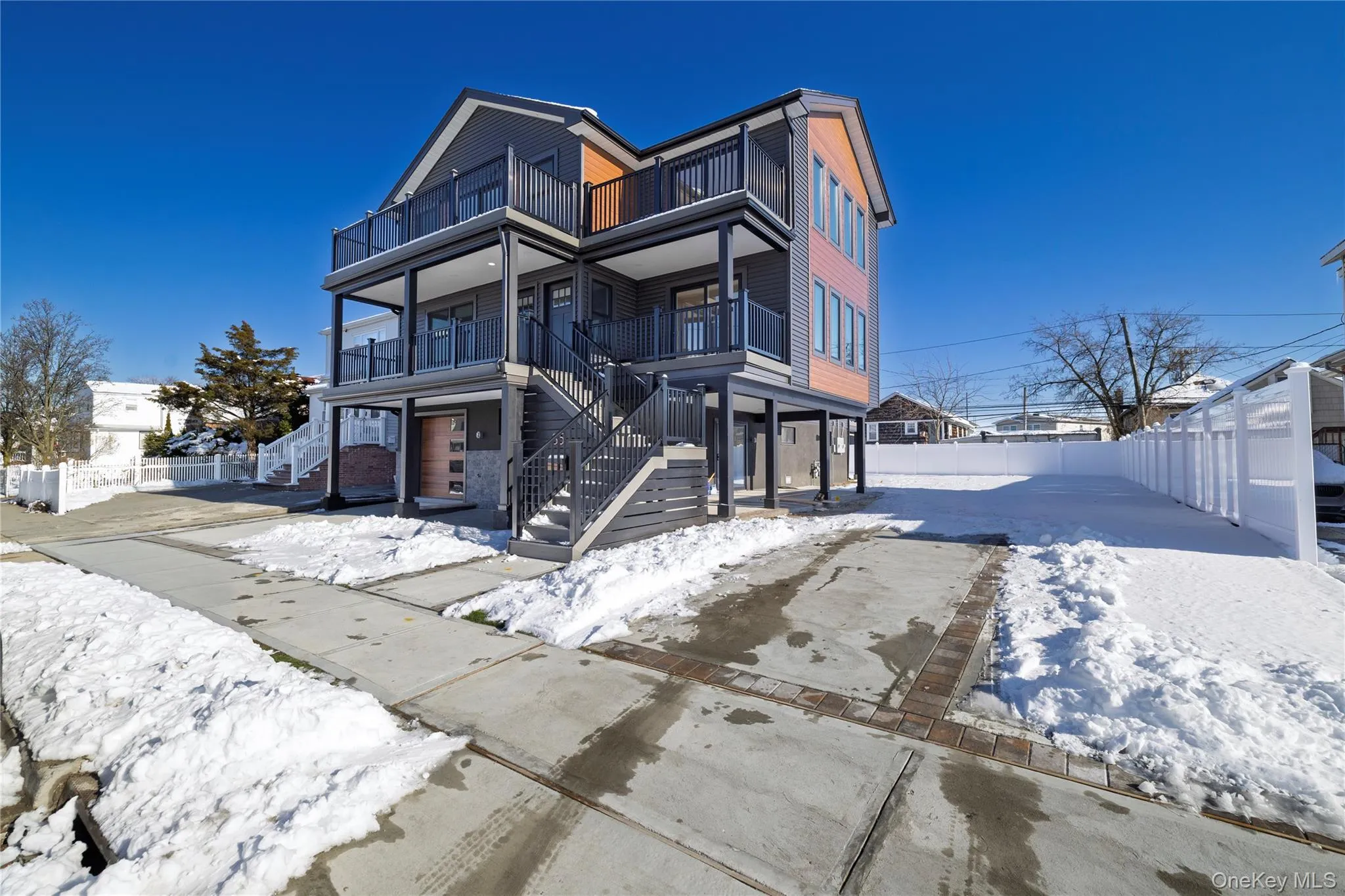 View of front facade featuring a fenced backyard and stairs View of front facade featuring a fenced backyard and stairs