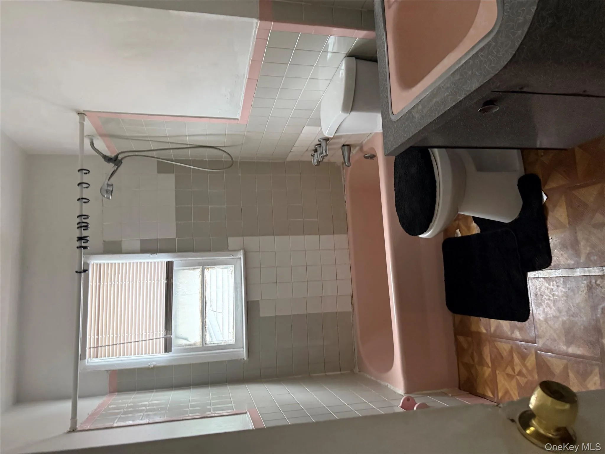 Full bath featuring bathing tub / shower combination, vanity, and tile walls Full bath featuring bathing tub / shower combination, vanity, and tile walls
