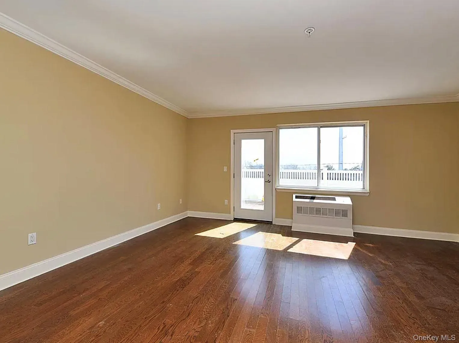 Unfurnished room featuring dark wood-style floors and crown molding Unfurnished room featuring dark wood-style floors and crown molding
