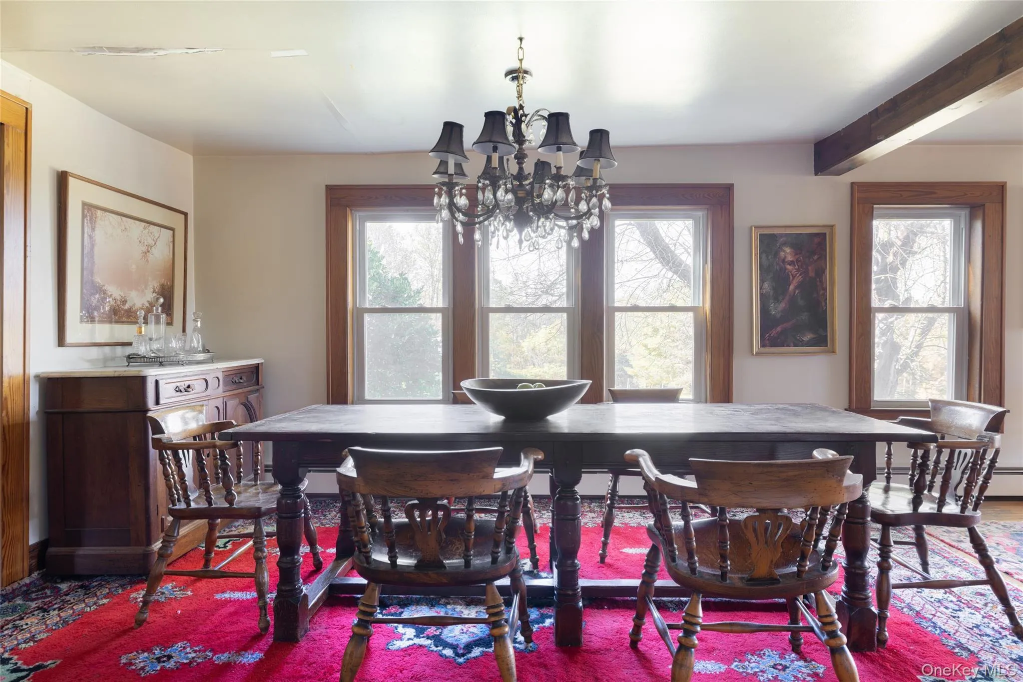 Dining space with a chandelier and beam ceiling Dining space with a chandelier and beam ceiling
