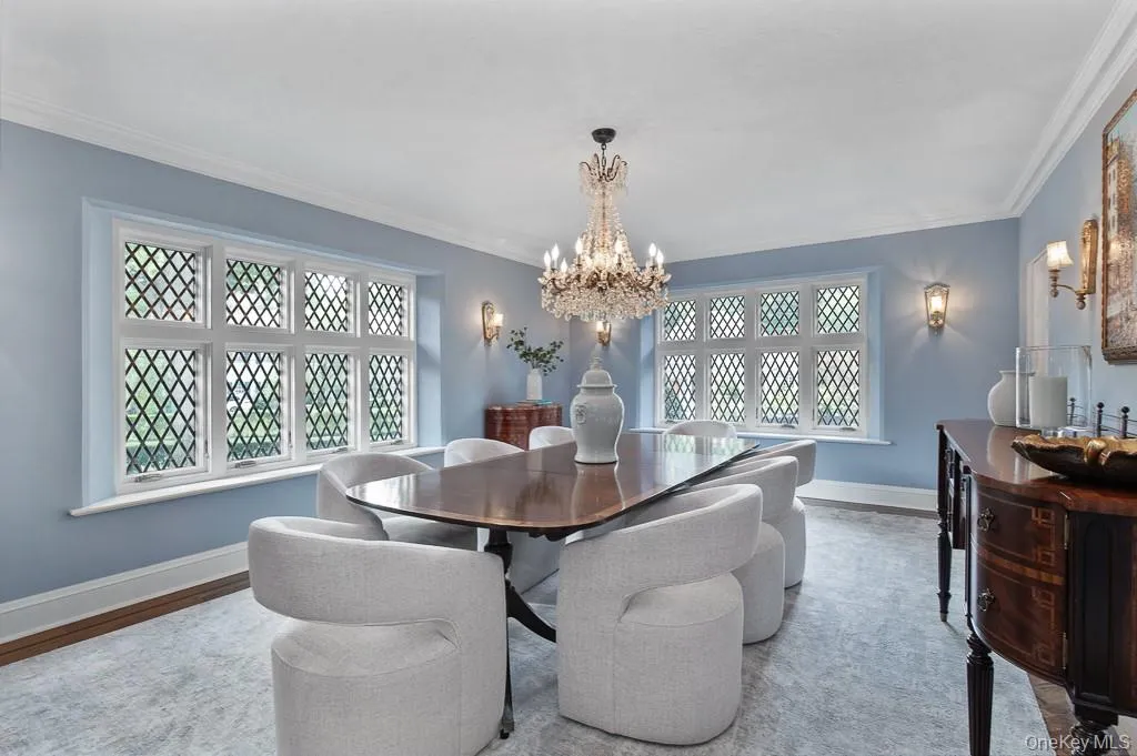 The generously-scaled formal dining room offers an elegant setting for entertaining and celebrations. The room is highlighted with beautifully restored casement windows. The generously-scaled formal dining room offers an elegant setting for entertaining and celebrations. The room is highlighted with beautifully restored casement windows.
