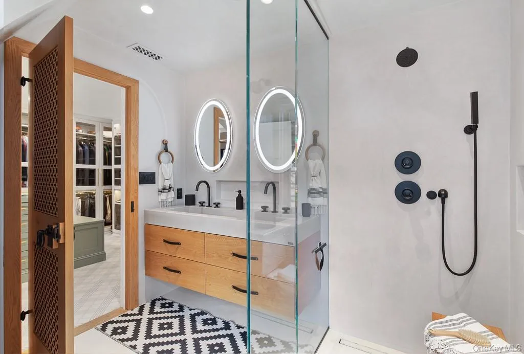 Another view of the ensuite bathroom off the dressing room showcases the beautiful detailing on the bathroom door. Another view of the ensuite bathroom off the dressing room showcases the beautiful detailing on the bathroom door.