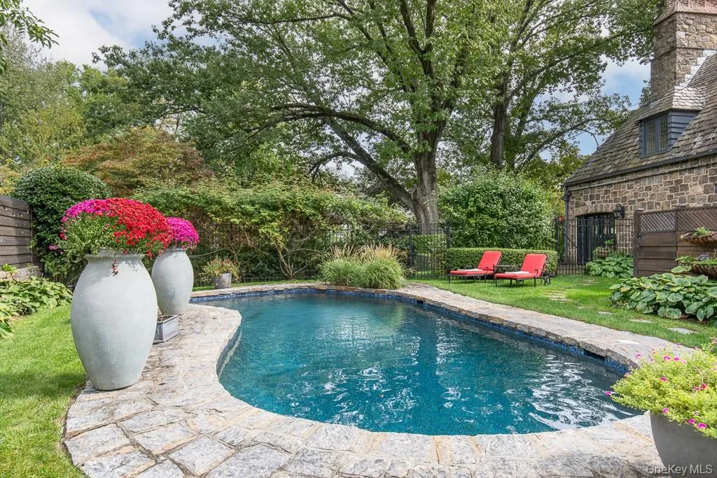 Nestled on nearly an acre of perfectly landscaped property with a newly refinished swimming pool, a beautiful wrap-around stone terrace, and several stone patios create a seamless indoor-outdoor lifestyle thoughtfully designed around the enchanting and private setting. Nestled on nearly an acre of perfectly landscaped property with a newly refinished swimming pool, a beautiful wrap-around stone terrace, and several stone patios create a seamless indoor-outdoor lifestyle thoughtfully designed around the enchanting and private setting.