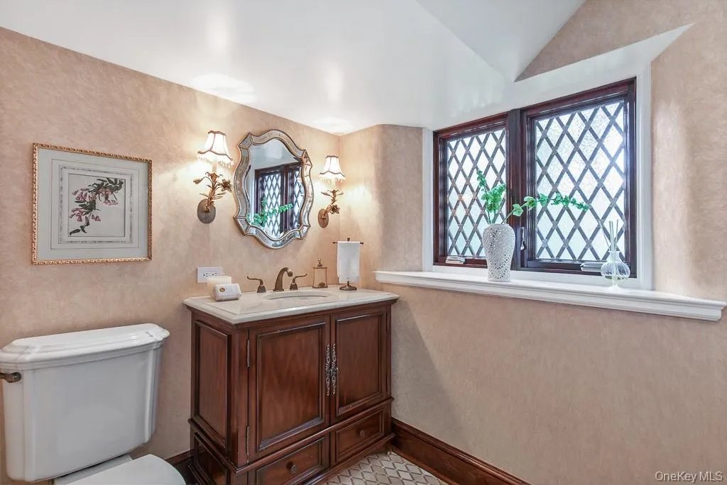 The formal powder room is discretely positioned off the entrance hall and features beautiful finishes. The formal powder room is discretely positioned off the entrance hall and features beautiful finishes.