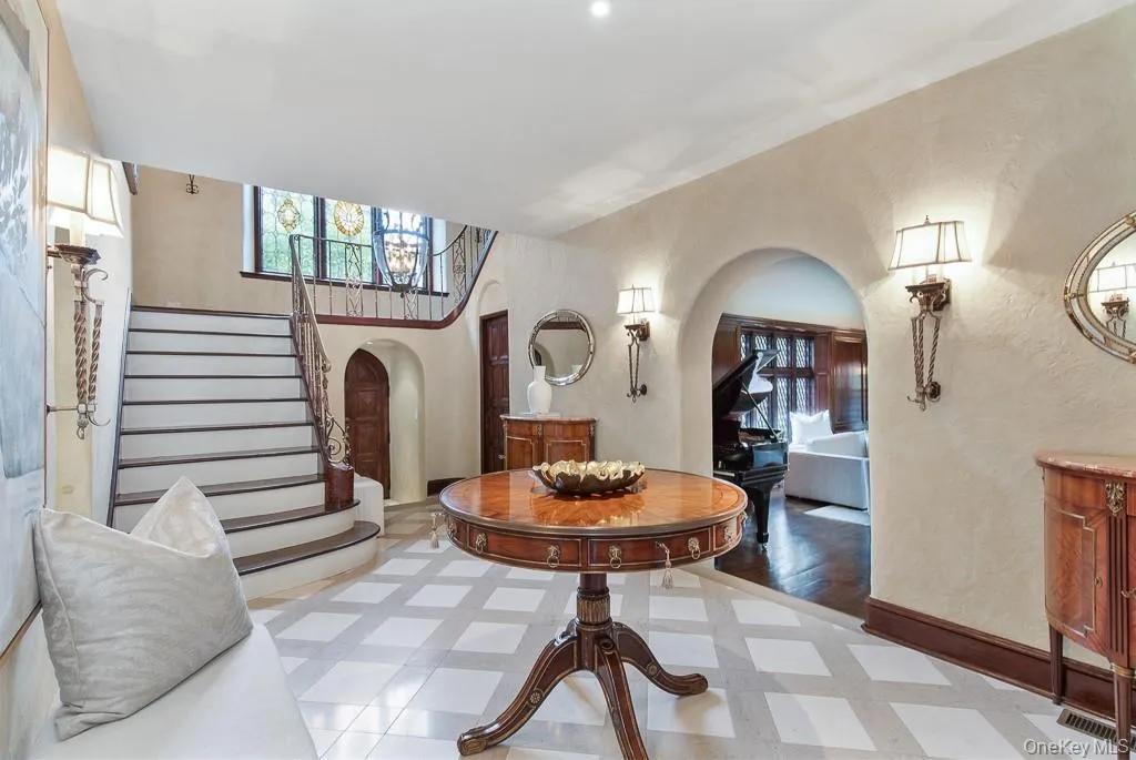 Additional view of the formal entrance hall gives a glimpse of the majestic formal living room. Additional view of the formal entrance hall gives a glimpse of the majestic formal living room.