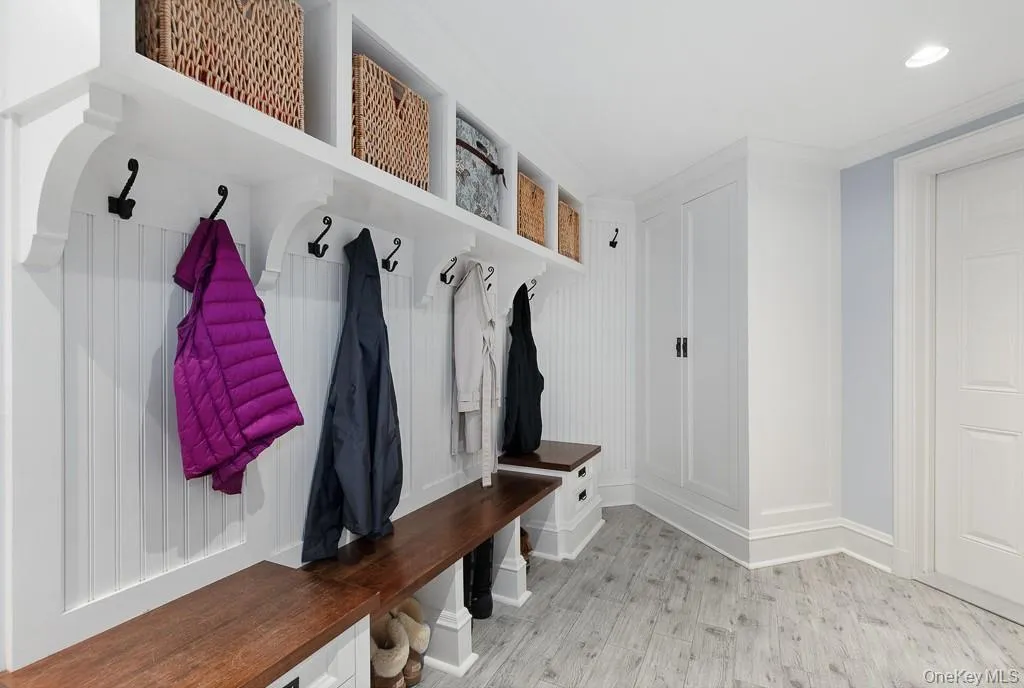 The mudroom features custom built-ins and seating is located right by the attached garage located on the finished lower level. The mudroom features custom built-ins and seating is located right by the attached garage located on the finished lower level.