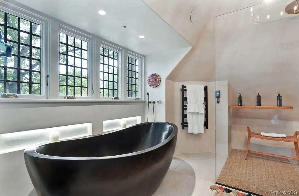 The AMAZING spa-style primary bathroom features a hand-carved soaking tub, dual sinks, an oversized shower, and incredible sauna. The AMAZING spa-style primary bathroom features a hand-carved soaking tub, dual sinks, an oversized shower, and incredible sauna.