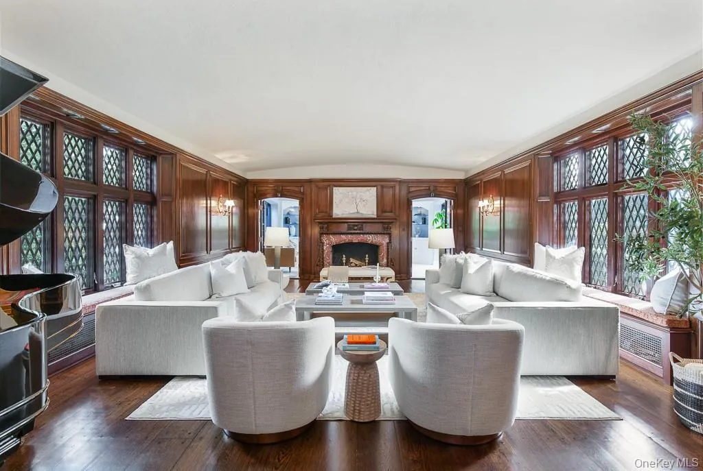 The majestic formal living room is detailed with a barreled ceiling, restored Cuban mahogany wood panelling, an and original wood-burning fireplace with a rare Rosso Levanto marble surround and herringbone limestone interior. Two sets of french doors open to a sun-filled office/study. The majestic formal living room is detailed with a barreled ceiling, restored Cuban mahogany wood panelling, an and original wood-burning fireplace with a rare Rosso Levanto marble surround and herringbone limestone interior. Two sets of french doors open to a sun-filled office/study.