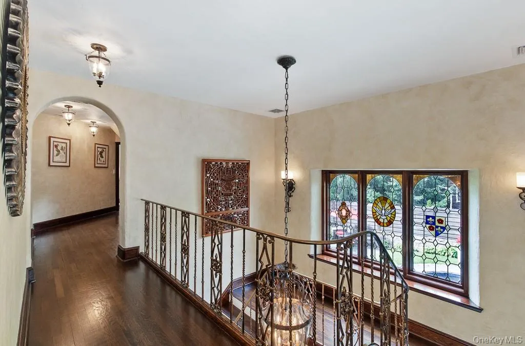 View of the second level showcases the spectacular stained glass windows and leads to three bedrooms and three full bathrooms and three full spa-style bathrooms, including the incredible primary bedroom suite. View of the second level showcases the spectacular stained glass windows and leads to three bedrooms and three full bathrooms and three full spa-style bathrooms, including the incredible primary bedroom suite.