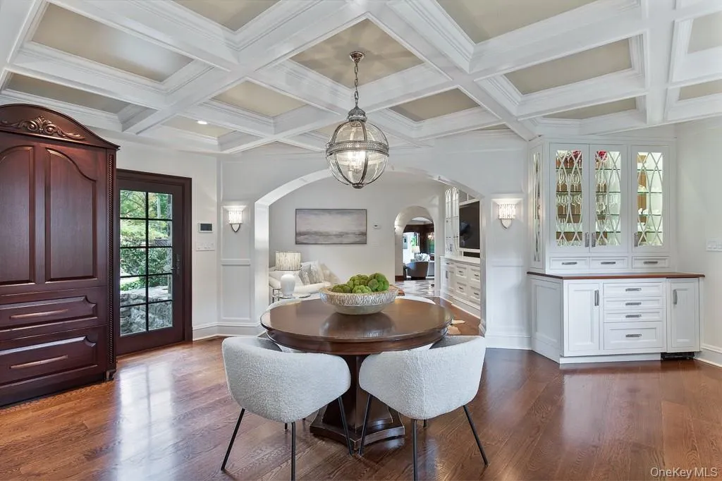The luxurious kitchen adjoins the formal dining room and features a breakfast area, butler's pantry, coffered ceilings and top of the line appliances that are concealed behind beautiful panelling. View of the open kitchen with breakfast area also showcases the family room. The luxurious kitchen adjoins the formal dining room and features a breakfast area, butler's pantry, coffered ceilings and top of the line appliances that are concealed behind beautiful panelling. View of the open kitchen with breakfast area also showcases the family room.