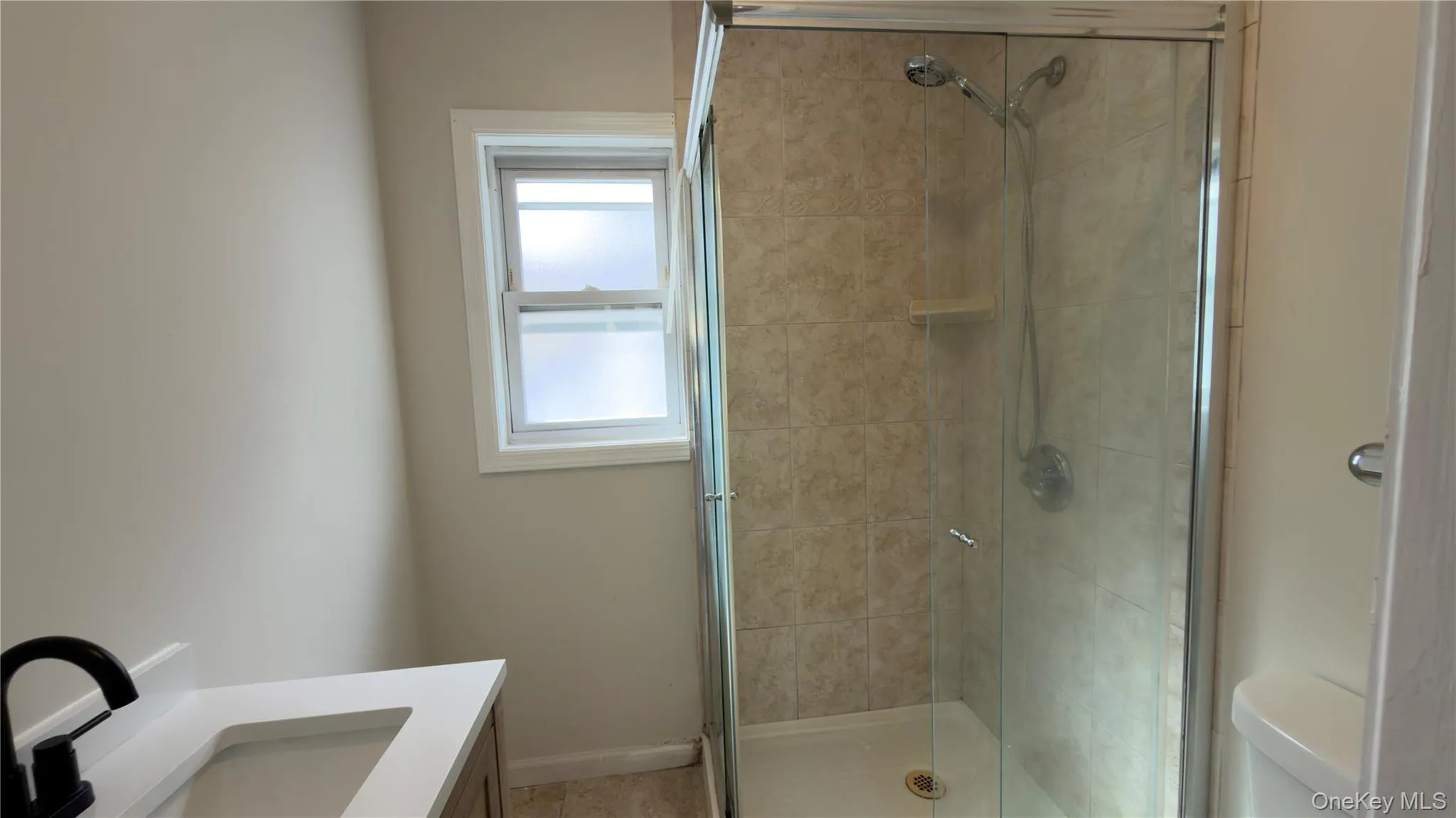 Bathroom featuring a stall shower and vanity Bathroom featuring a stall shower and vanity