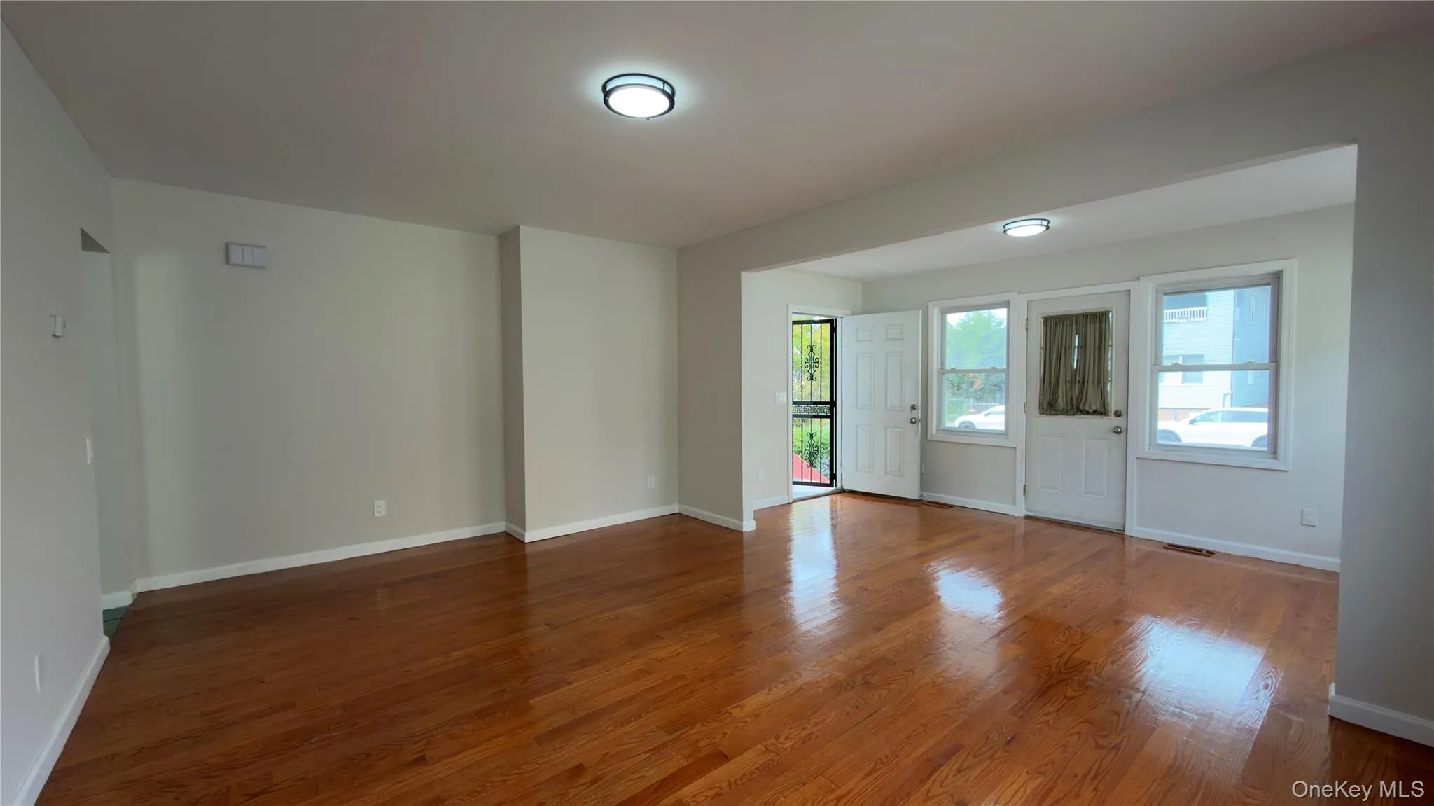Unfurnished room with wood finished floors and baseboards Unfurnished room with wood finished floors and baseboards