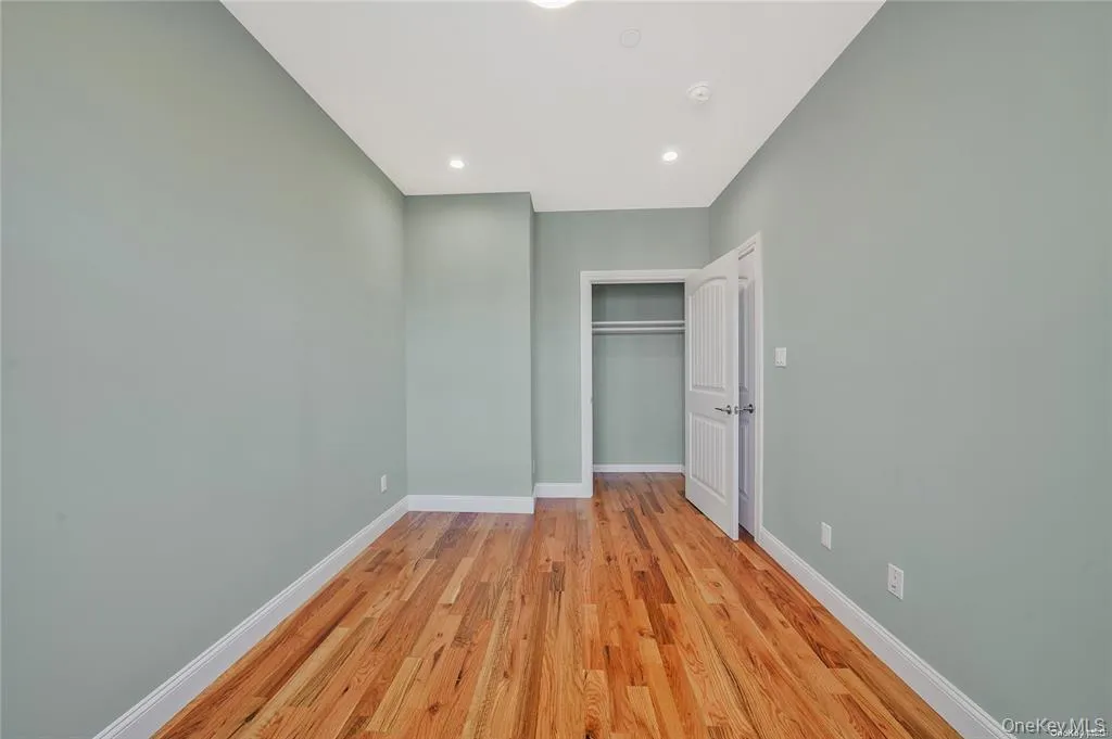Unfurnished bedroom with light wood-style flooring, a closet, and recessed lighting Unfurnished bedroom with light wood-style flooring, a closet, and recessed lighting