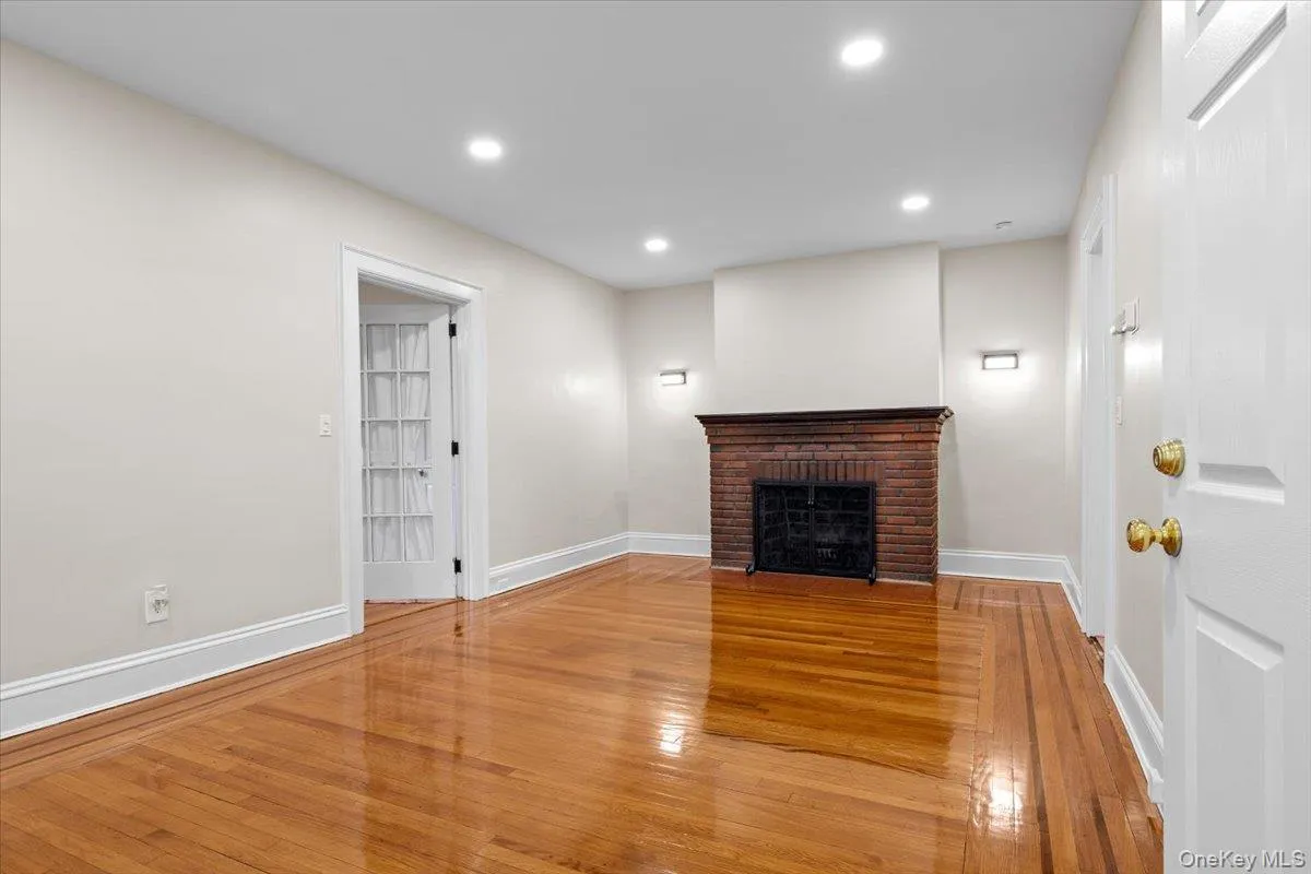 Unfurnished living room with recessed lighting, light wood finished floors, and a fireplace Unfurnished living room with recessed lighting, light wood finished floors, and a fireplace