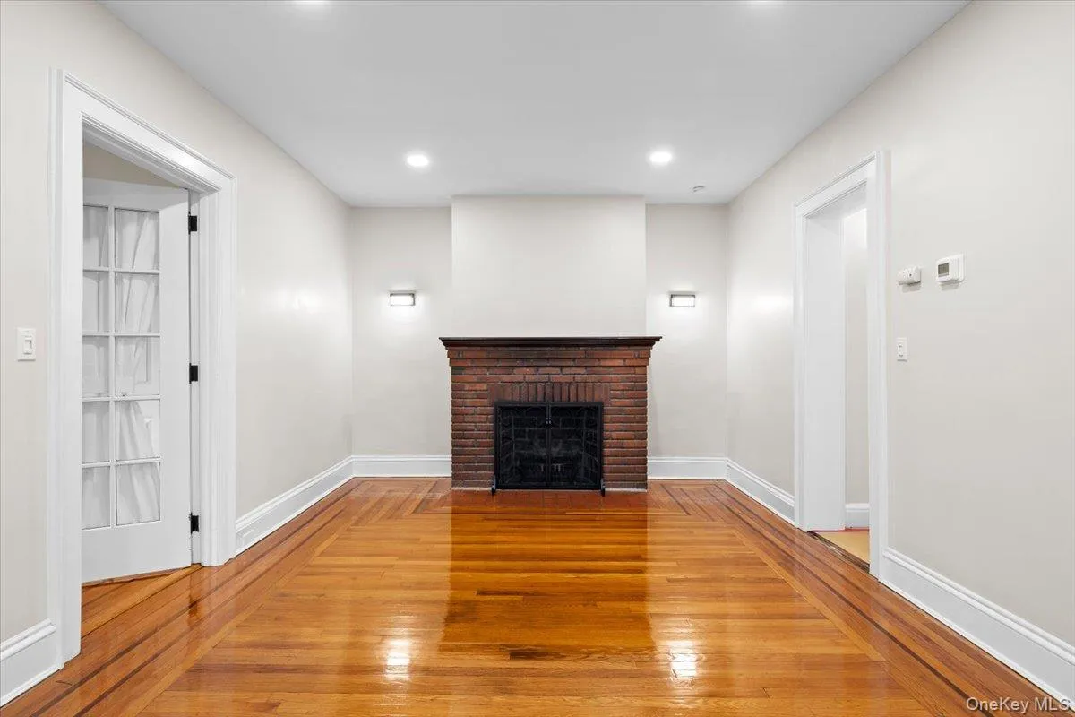 Unfurnished living room featuring light wood-style floors, recessed lighting, and a fireplace Unfurnished living room featuring light wood-style floors, recessed lighting, and a fireplace