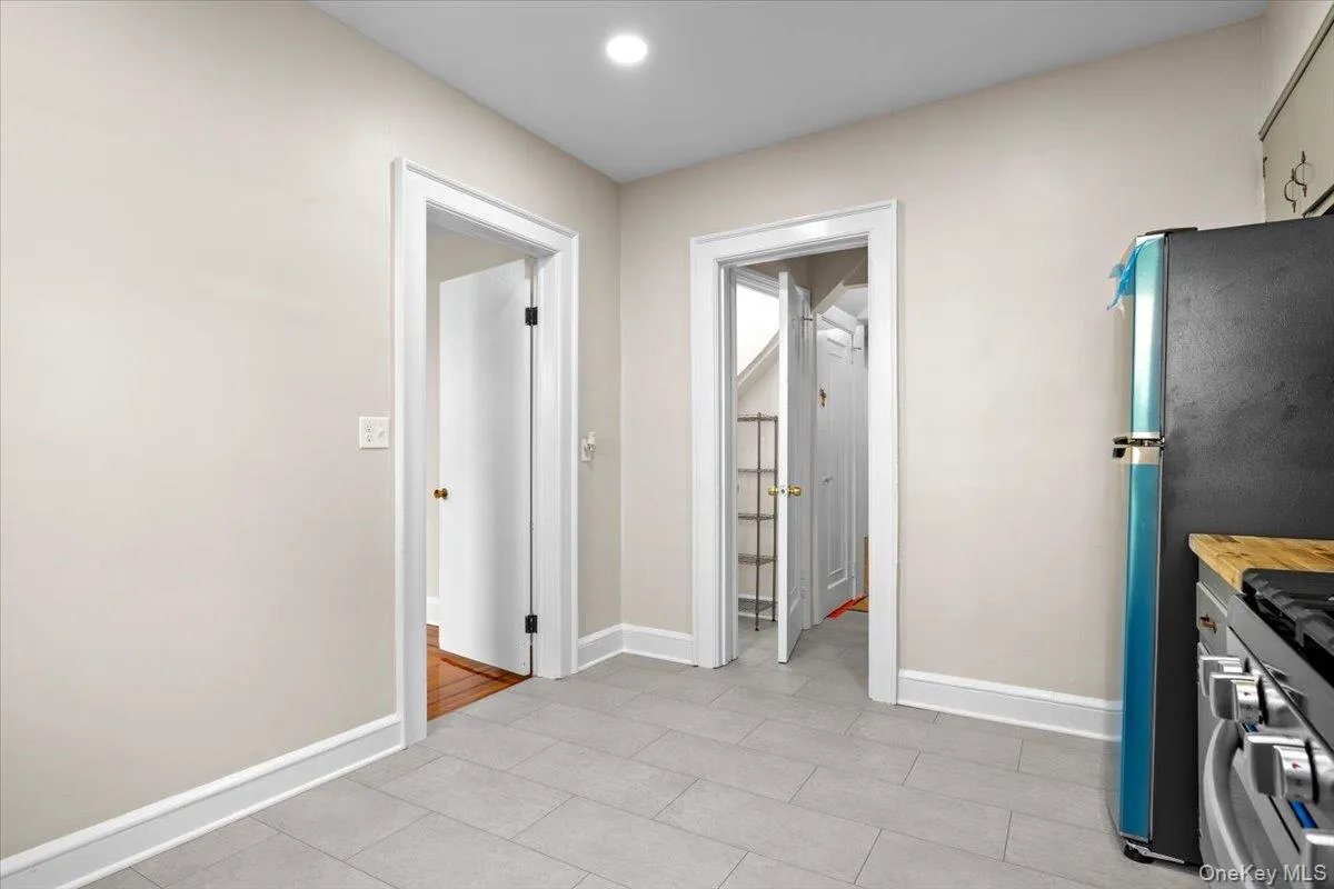 Kitchen featuring butcher block counters, recessed lighting, and light tile patterned floors Kitchen featuring butcher block counters, recessed lighting, and light tile patterned floors