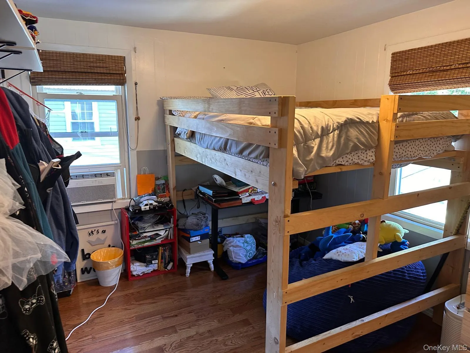 Bedroom featuring dark wood-type flooring and cooling unit Bedroom featuring dark wood-type flooring and cooling unit