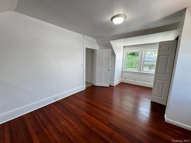Bonus room with dark wood-style floors Bonus room with dark wood-style floors