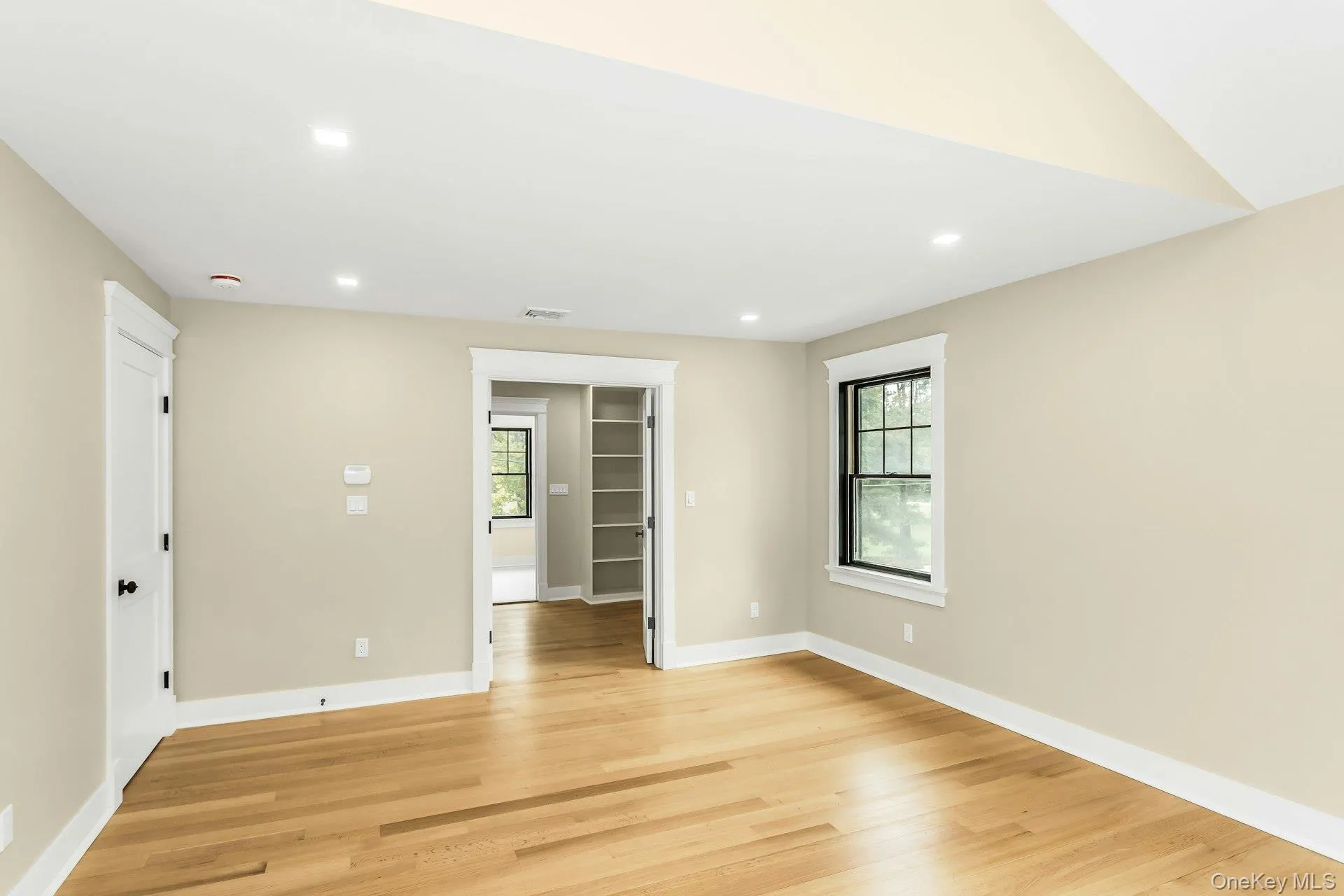Empty room with plenty of natural light, light wood-type flooring, and recessed lighting Empty room with plenty of natural light, light wood-type flooring, and recessed lighting