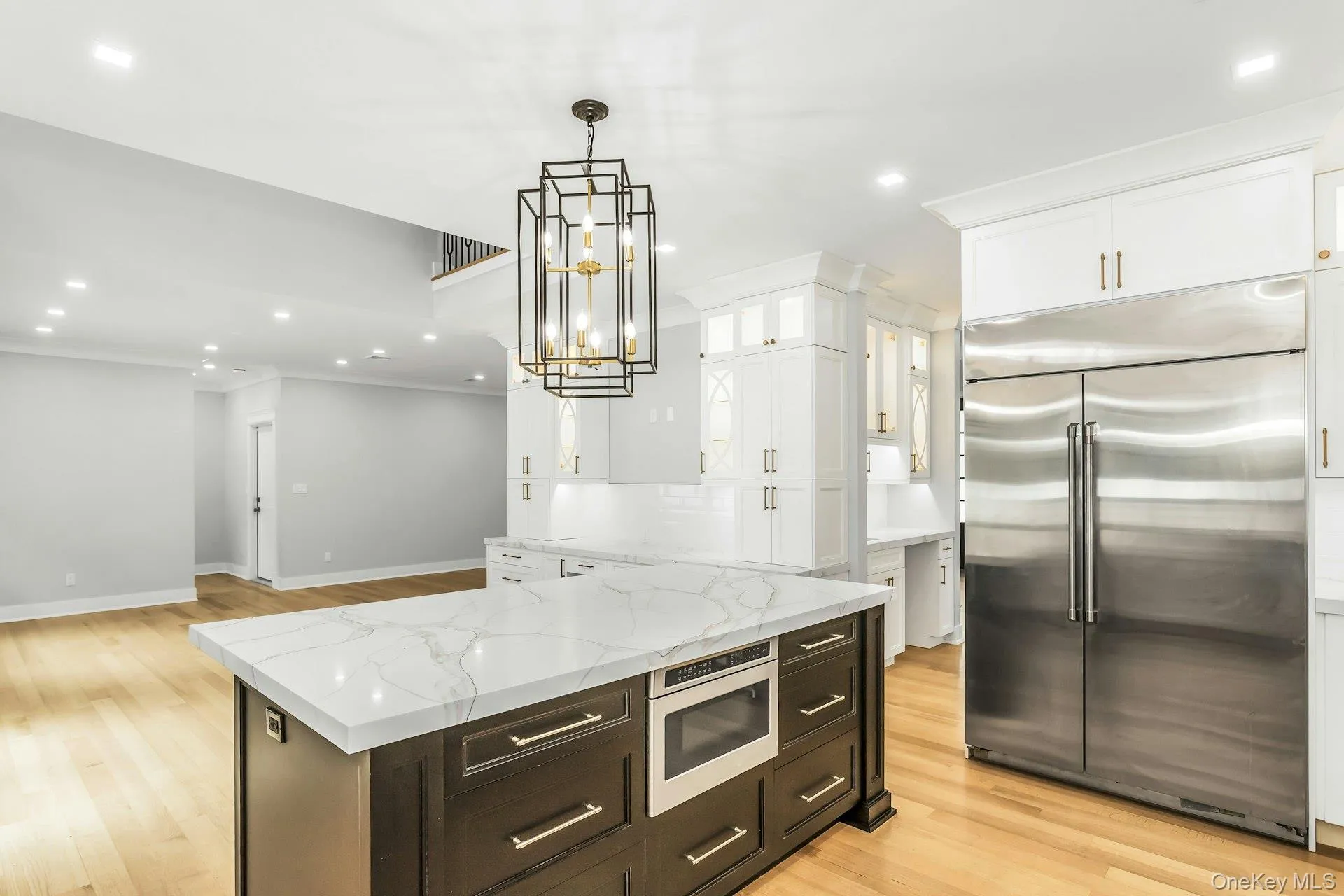 Kitchen with built in appliances, recessed lighting, white cabinetry, light wood-style floors, and open floor plan Kitchen with built in appliances, recessed lighting, white cabinetry, light wood-style floors, and open floor plan