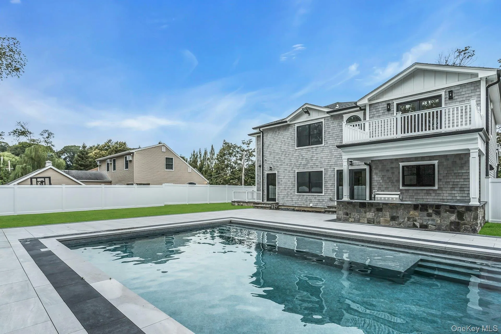 View of pool featuring a patio, a fenced backyard, and a balcony View of pool featuring a patio, a fenced backyard, and a balcony