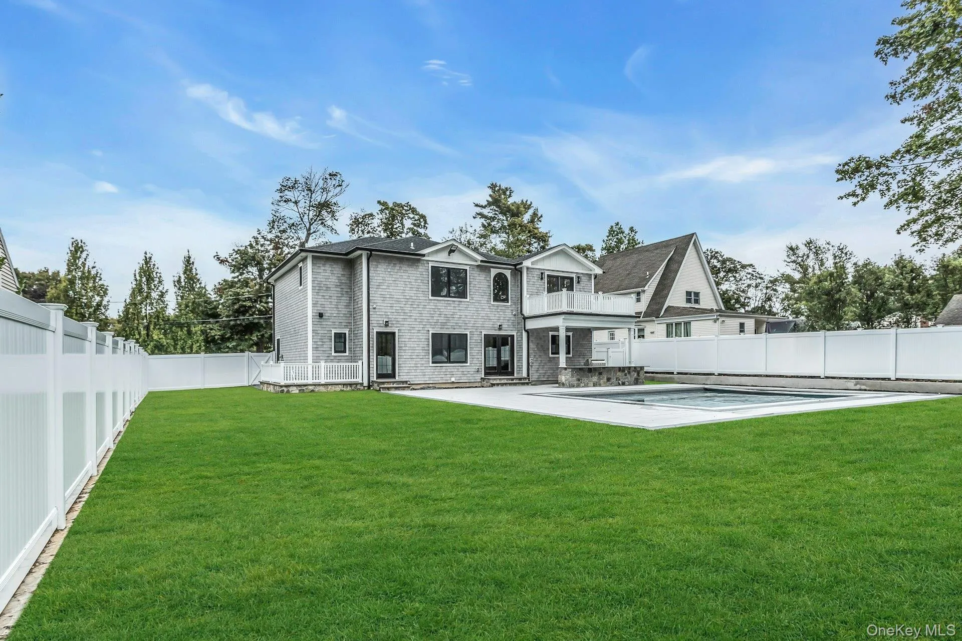 Rear view of property featuring a fenced backyard, a patio area, and a balcony Rear view of property featuring a fenced backyard, a patio area, and a balcony
