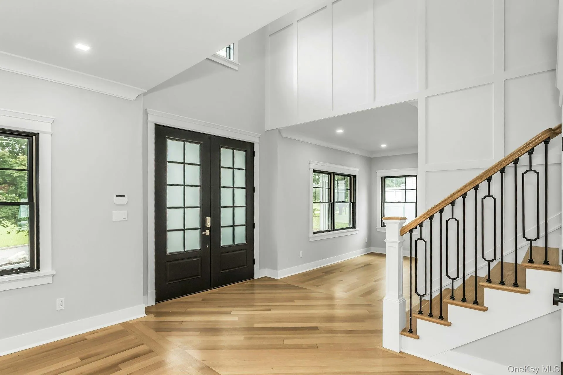 Entrance foyer with plenty of natural light, recessed lighting, stairway, french doors, and light wood-type flooring Entrance foyer with plenty of natural light, recessed lighting, stairway, french doors, and light wood-type flooring