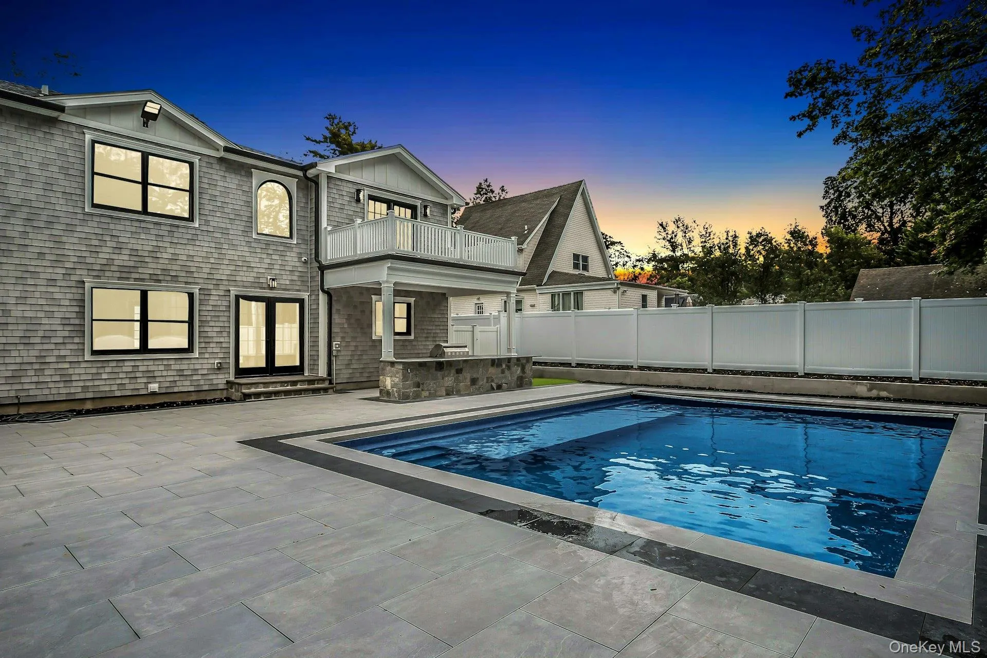 View of pool featuring a balcony, a patio, and a fenced backyard View of pool featuring a balcony, a patio, and a fenced backyard