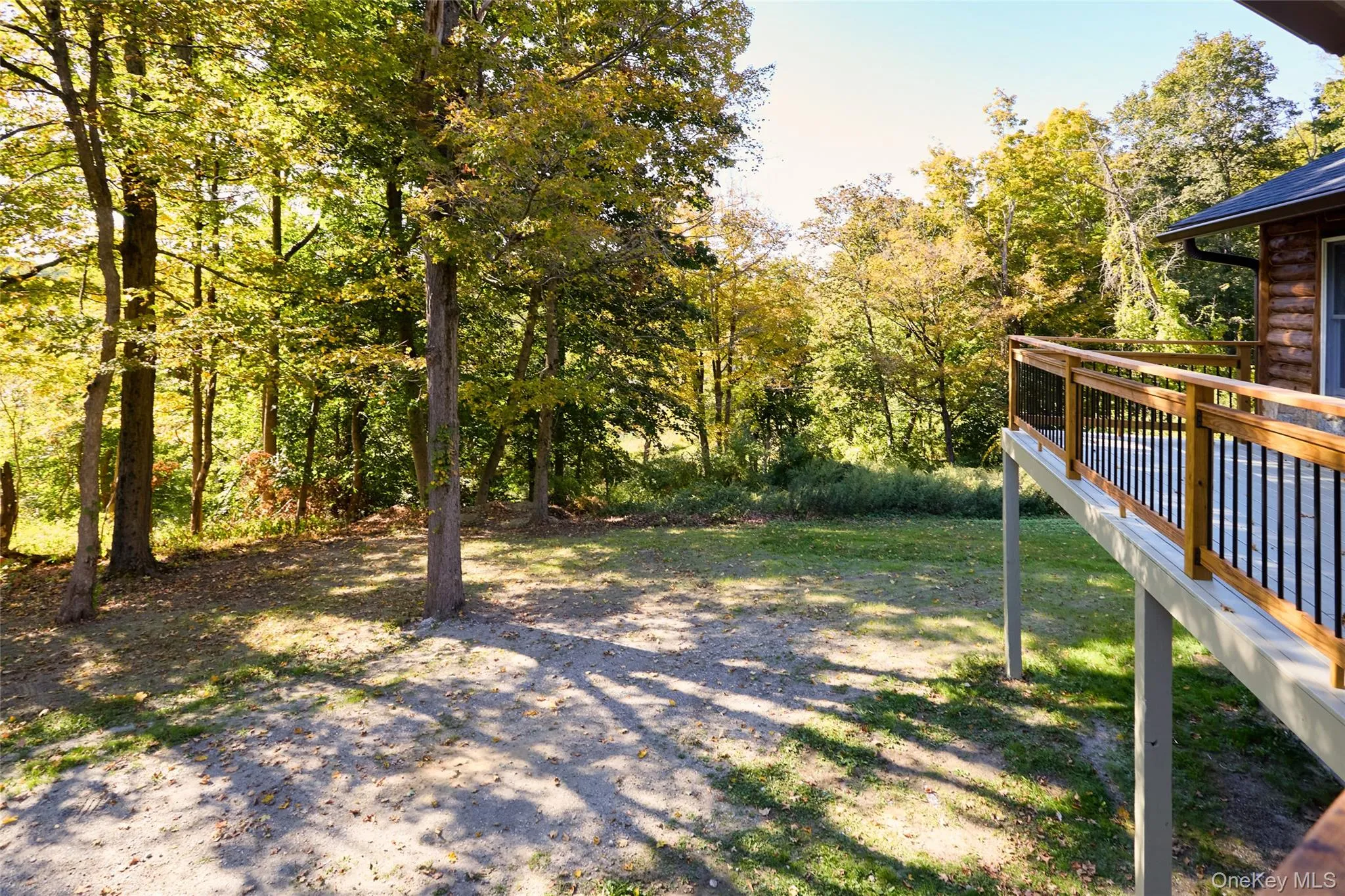 View of yard with a wooden deck View of yard with a wooden deck