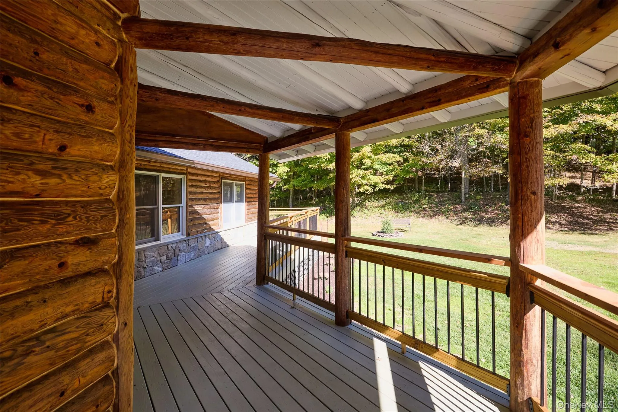 Wooden terrace featuring a lawn Wooden terrace featuring a lawn