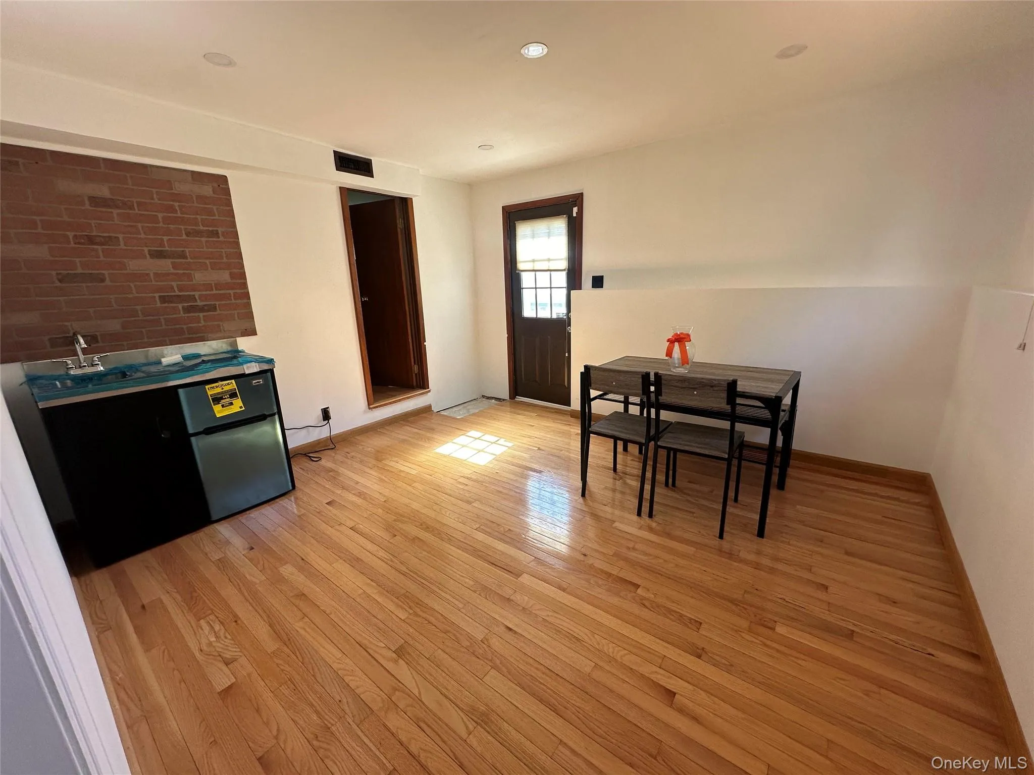 Dining area with light wood-style flooring and baseboards Dining area with light wood-style flooring and baseboards